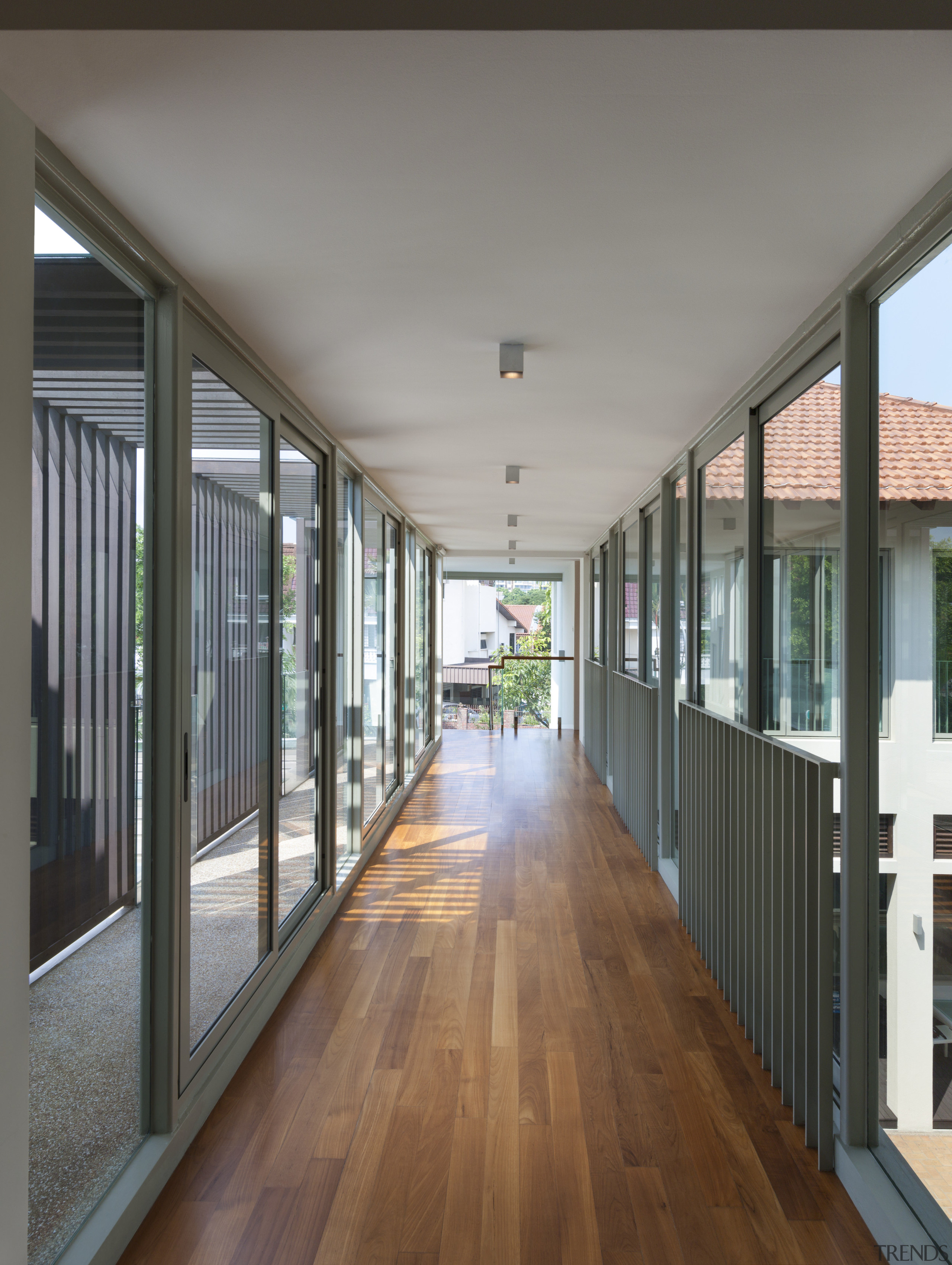 Glazing forms the sides of the bridge that apartment, architecture, balcony, daylighting, door, floor, flooring, handrail, home, house, property, real estate, window, wood, wood flooring, gray