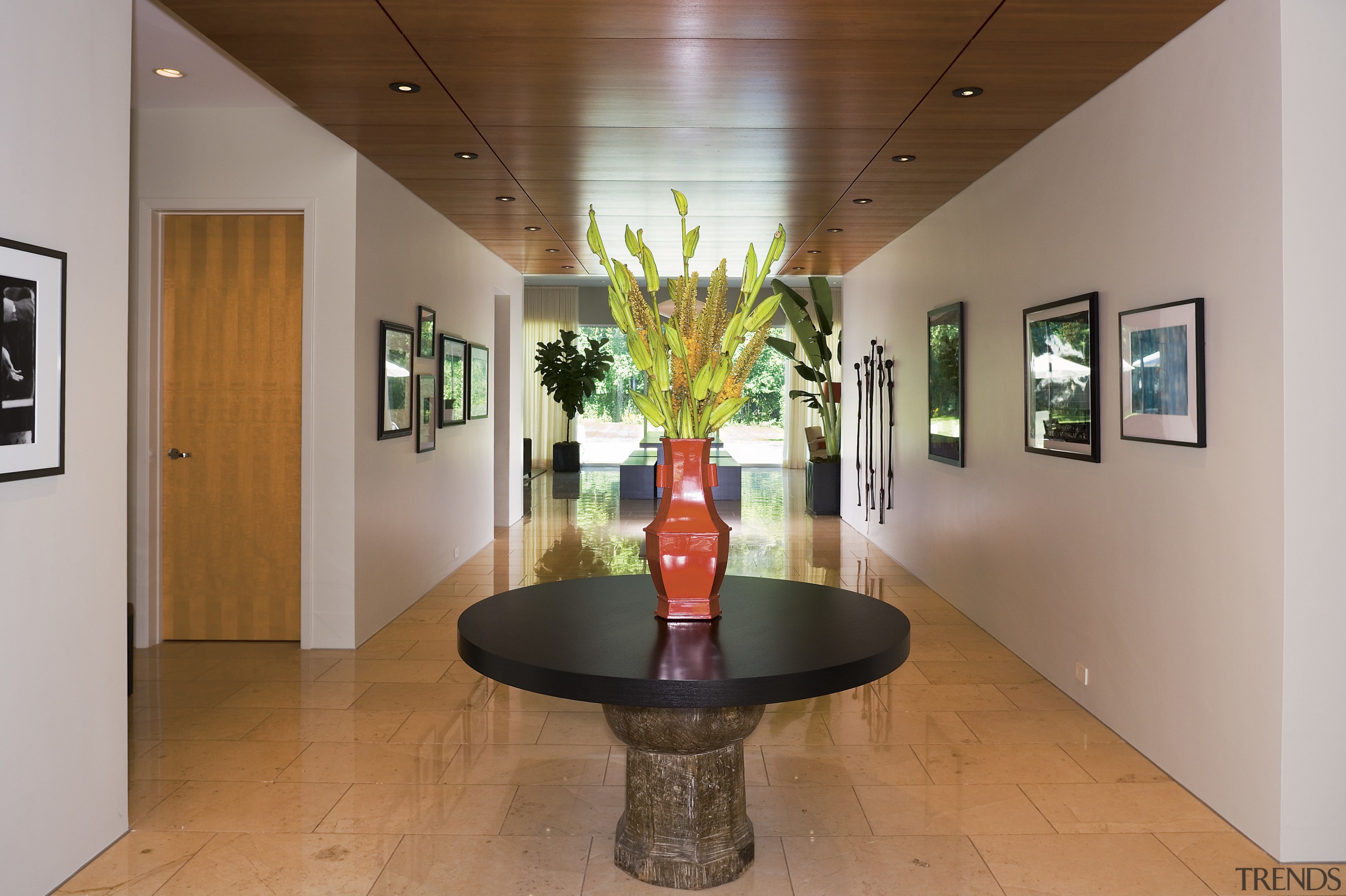 A view of a hallway, white walls, wooden ceiling, interior design, lobby, real estate, table, brown, gray