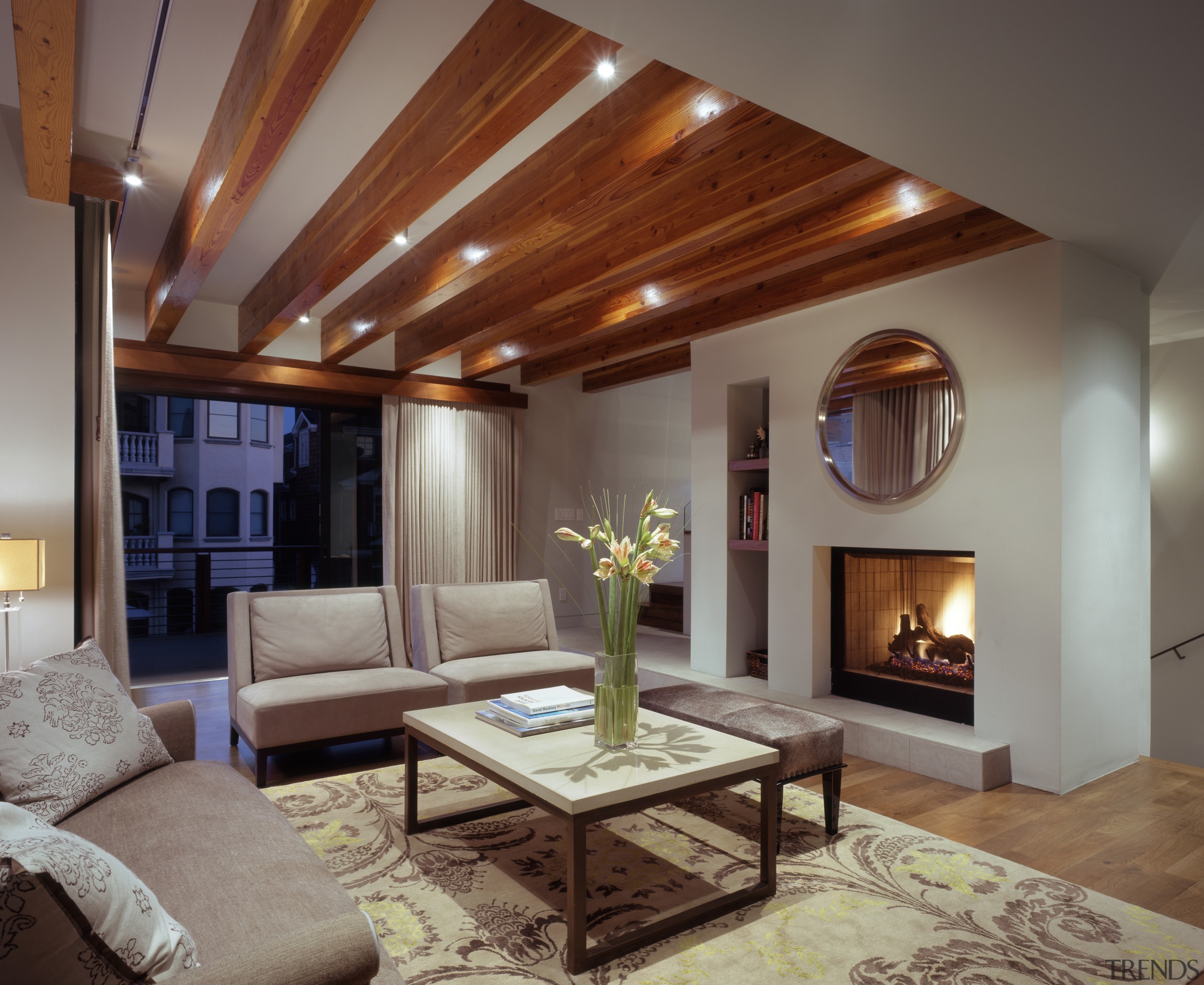 The living room ceiling features exposed beams. Custom ceiling, hardwood, home, interior design, living room, real estate, room, gray, brown