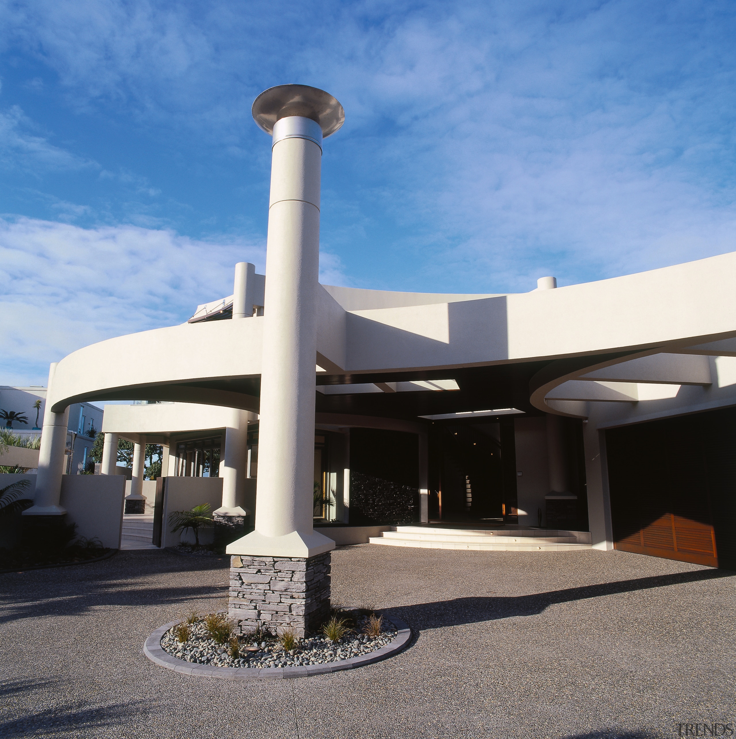 Entranceway of building with central column with schist architecture, structure, teal