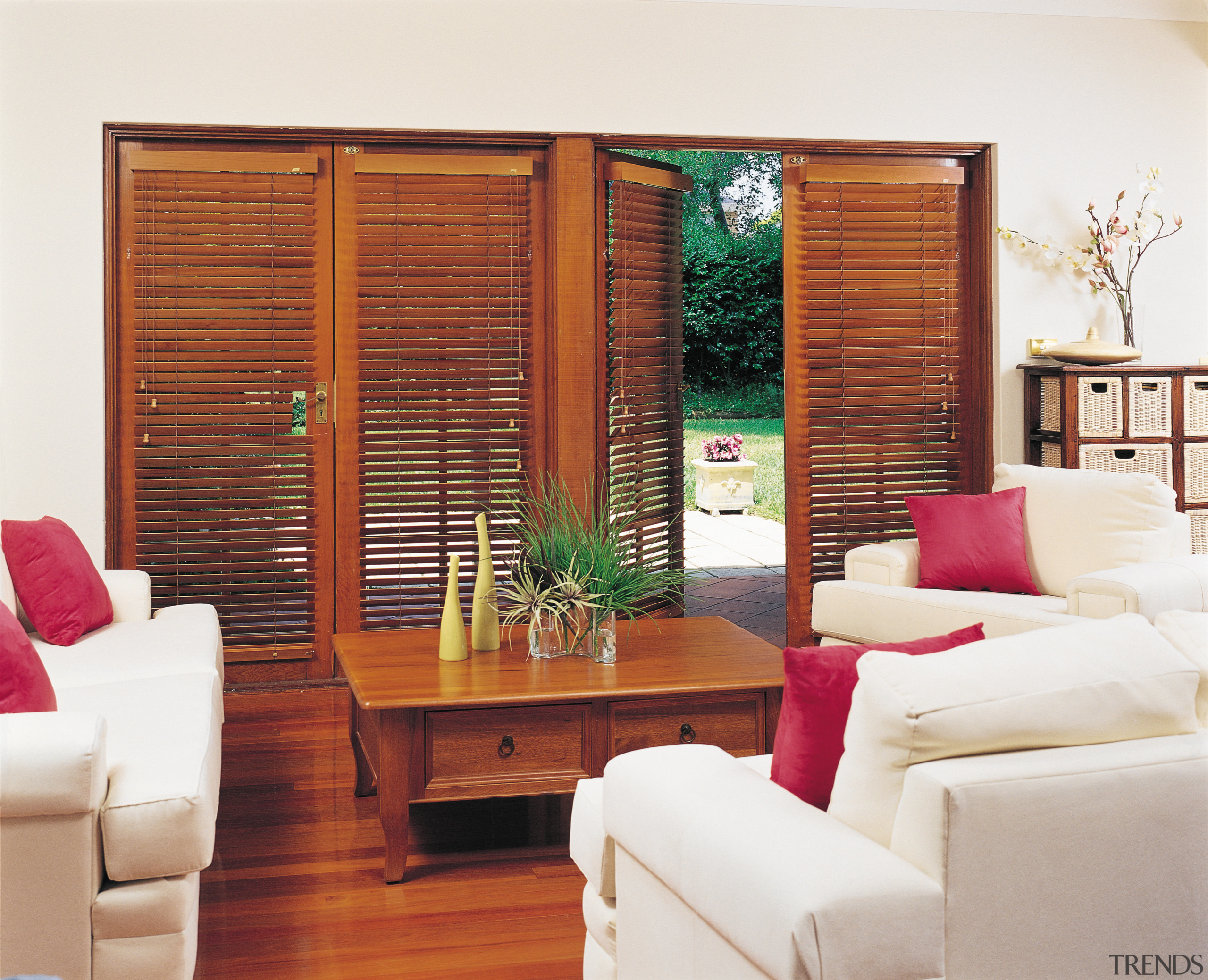 A view of some wooden shutters. - A door, furniture, hardwood, home, interior design, living room, window, window blind, window covering, window treatment, wood, white, red