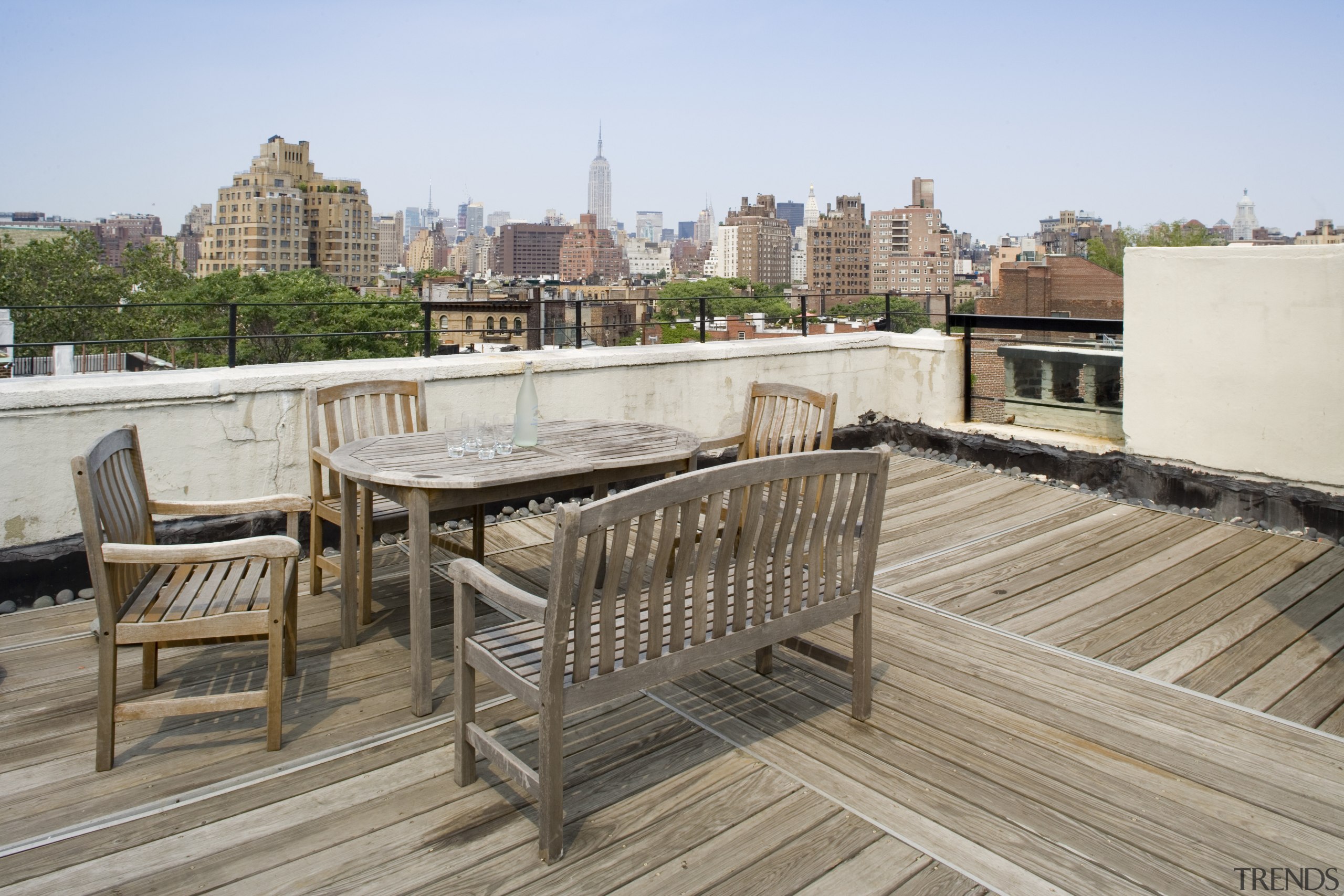 A view of the rooftop deck looking over apartment, condominium, deck, furniture, outdoor structure, property, real estate, roof, walkway, gray