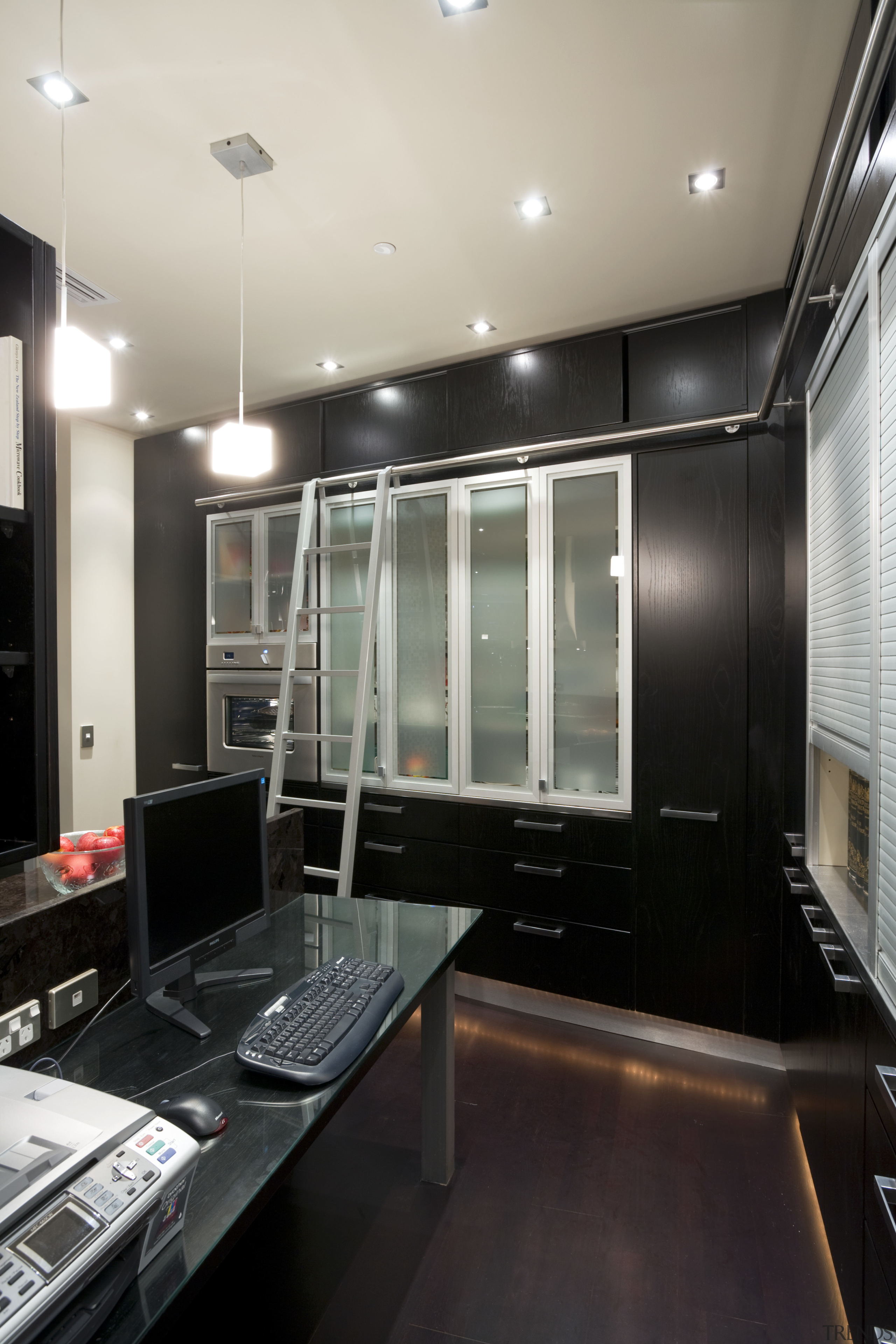 A suspended shelving unit further defines the kitchen's ceiling, countertop, interior design, kitchen, room, gray, black