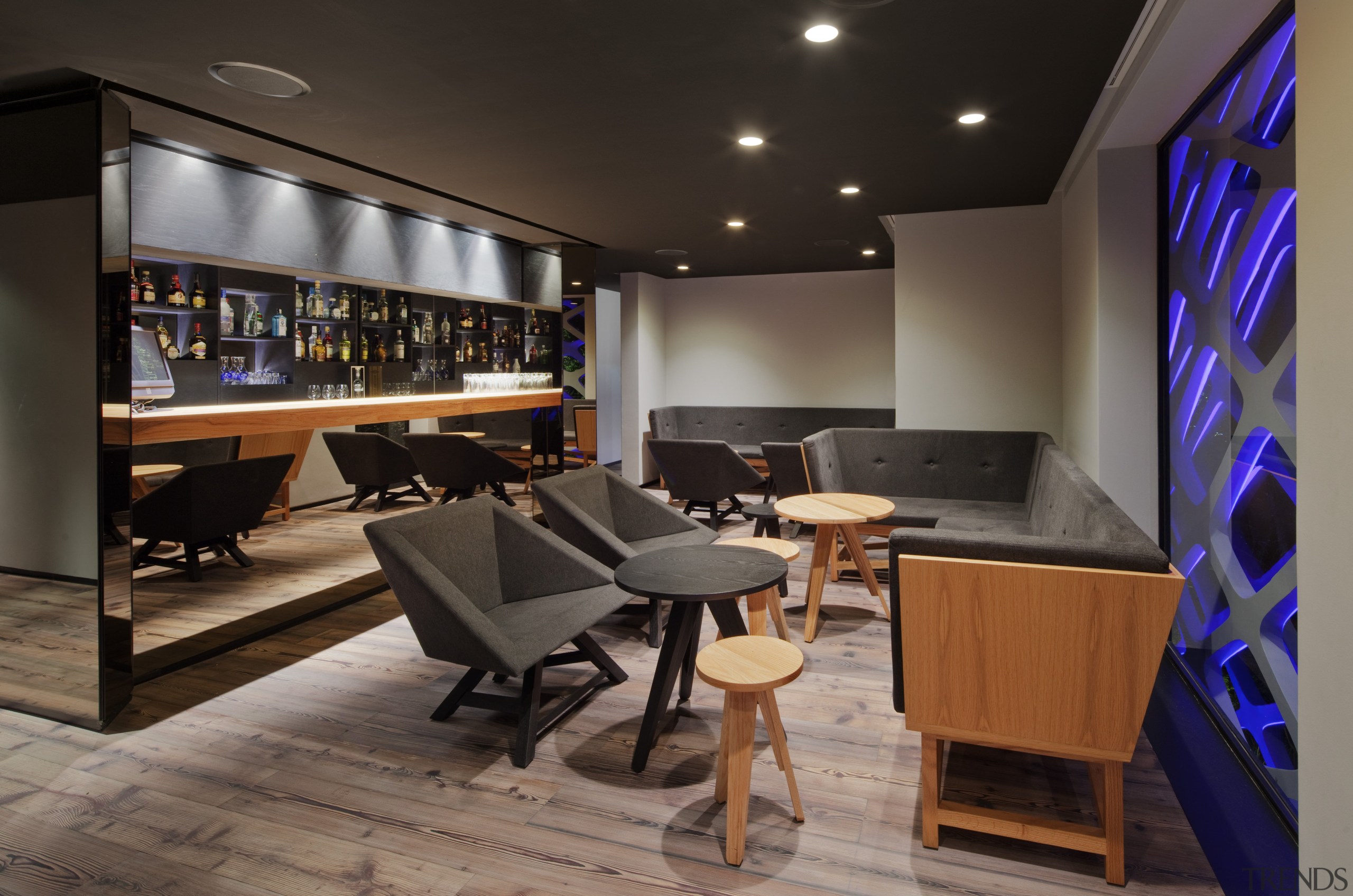 View of seating area and bar with grey interior design, black