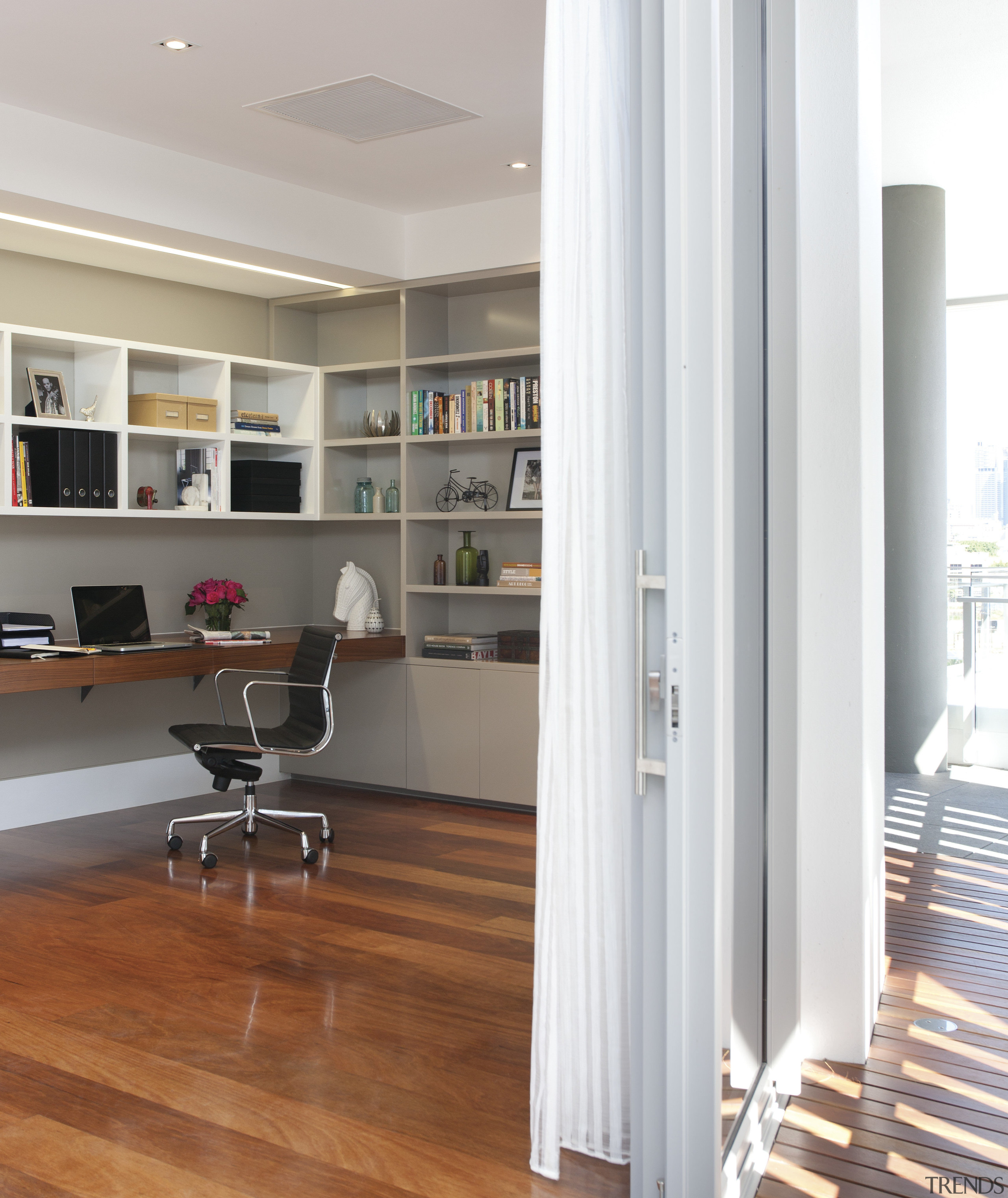 View of study area with wooden flooring. - bookcase, floor, flooring, furniture, hardwood, interior design, laminate flooring, living room, shelf, shelving, wall, wood, wood flooring, gray, white