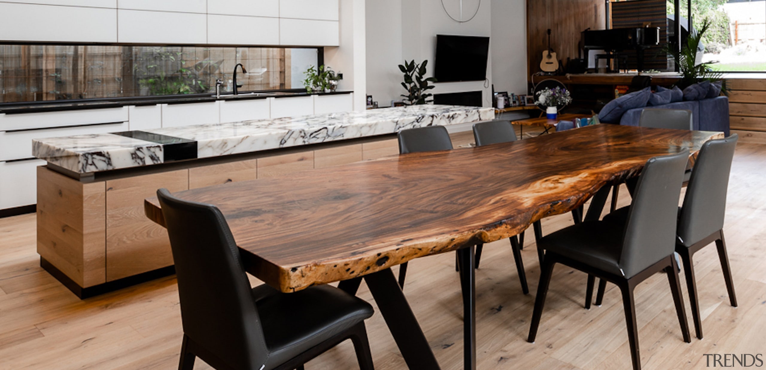 The kitchen island runs adjacent to the timber 