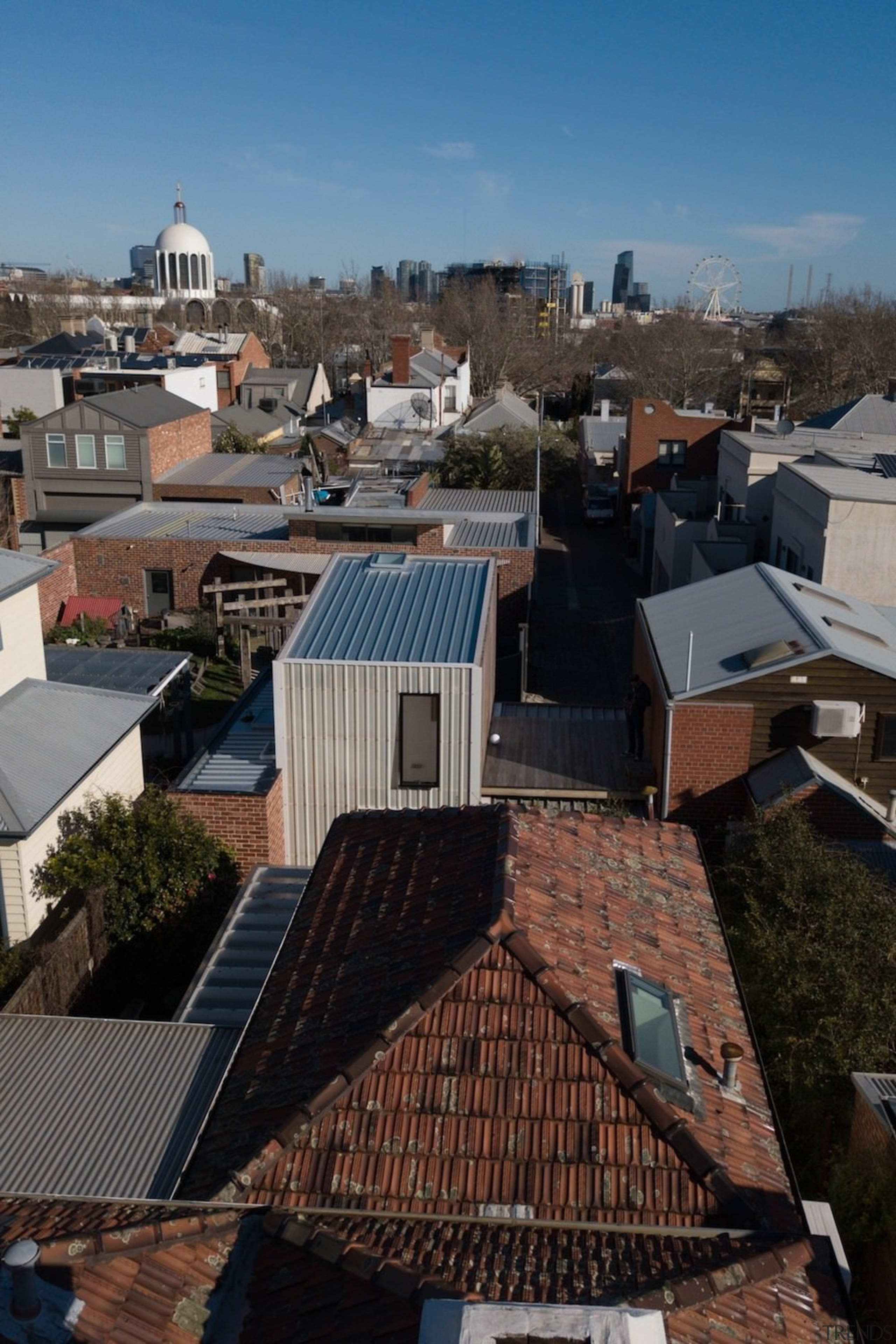 The studio blends into the surrounding neighbourhood architecture, building, city, home, house, neighbourhood, outdoor structure, real estate, residential area, roof, sky, suburb, town, urban area, black