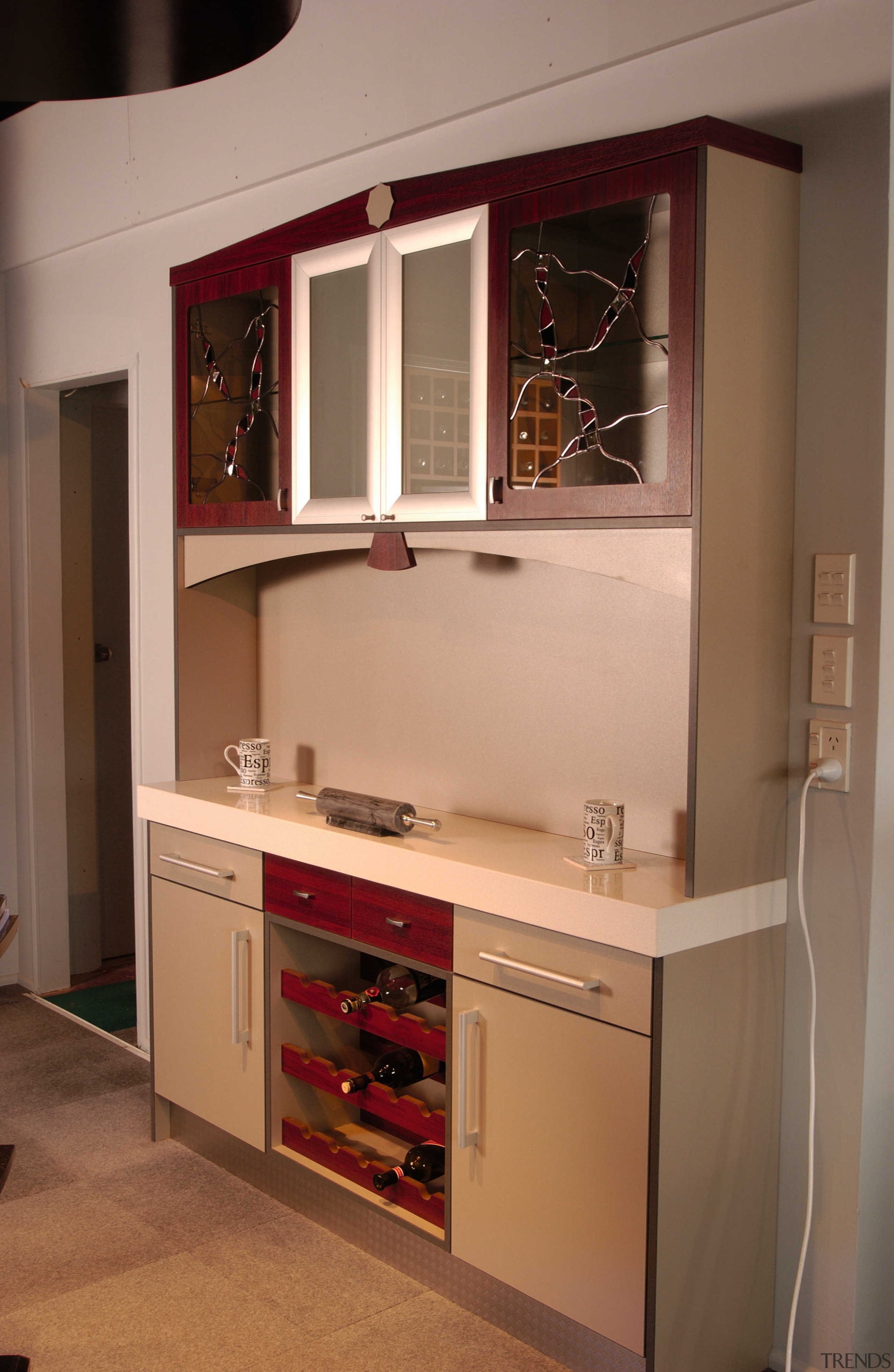 Showroom kitchen with tan and redwood coloured cabinetry, bathroom accessory, cabinetry, countertop, cuisine classique, furniture, interior design, kitchen, room, shelf, shelving, brown, orange