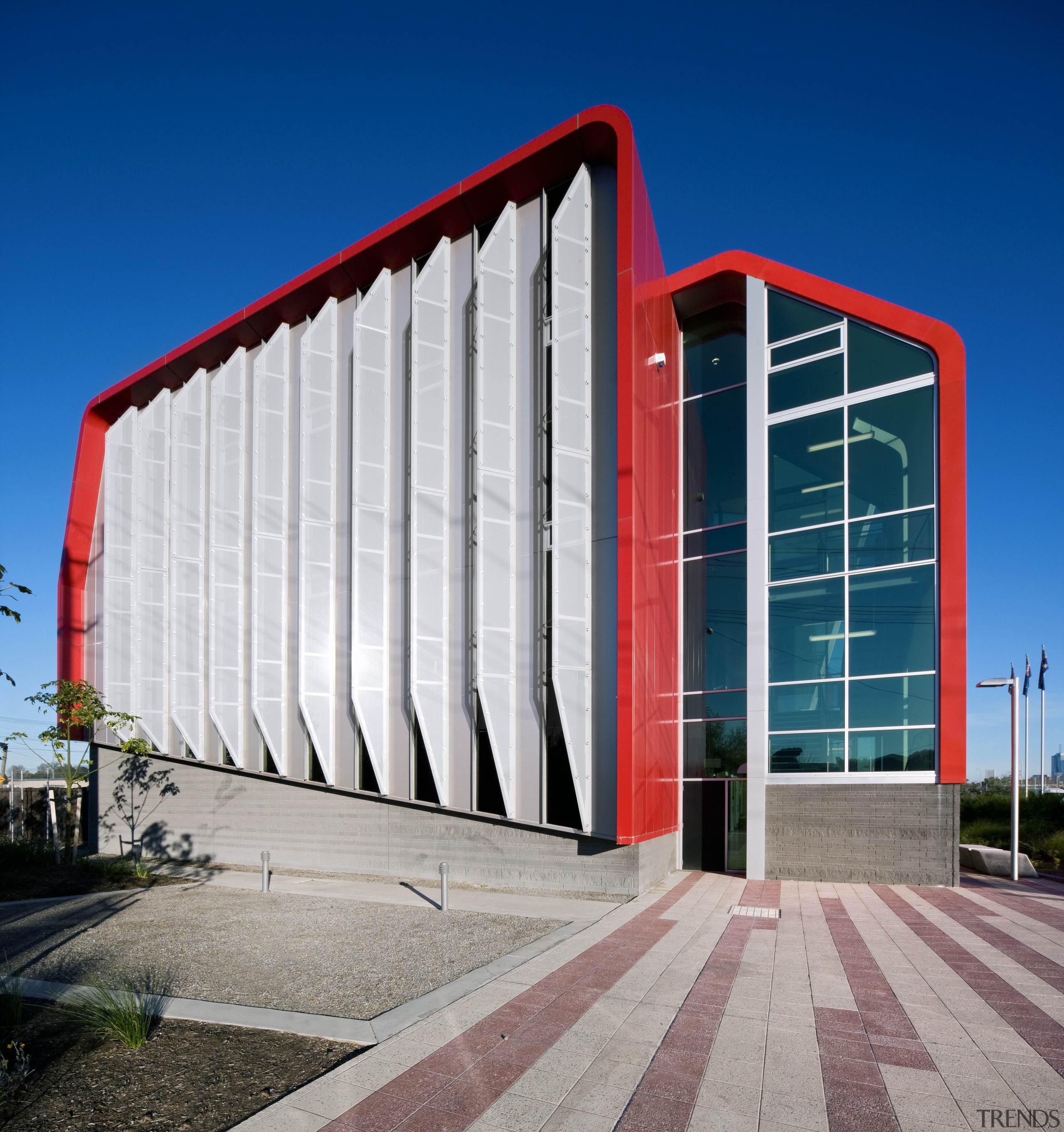 Vertical glass fins on the west facade help architecture, building, commercial building, corporate headquarters, daytime, facade, headquarters, landmark, metropolitan area, residential area, sky, structure, blue