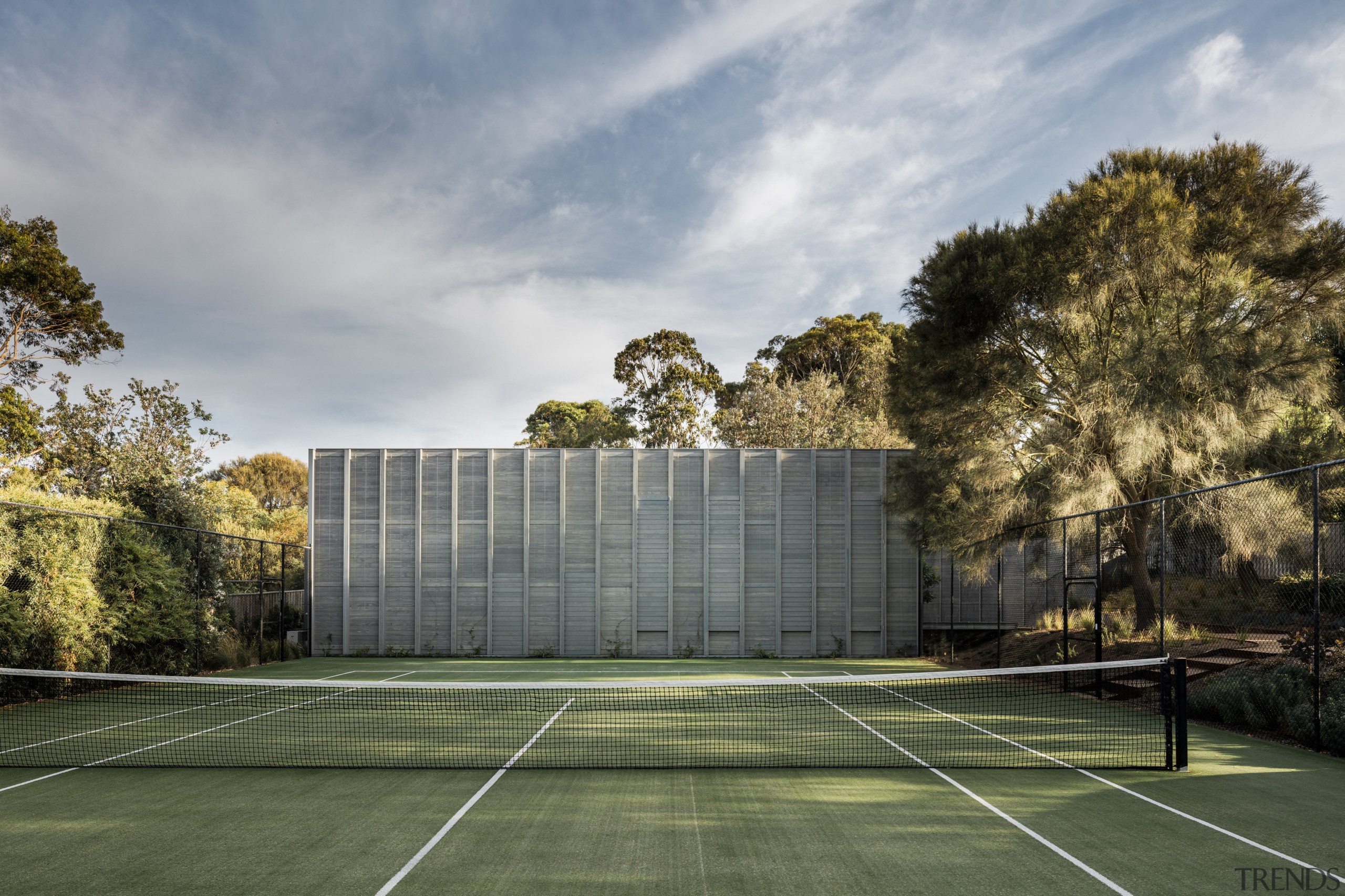 Not only is this new home in a architecture, area, building, cloud, daytime, estate, grass, house, landscape, plant, real estate, residential area, sky, sport venue, structure, sunlight, tree, gray