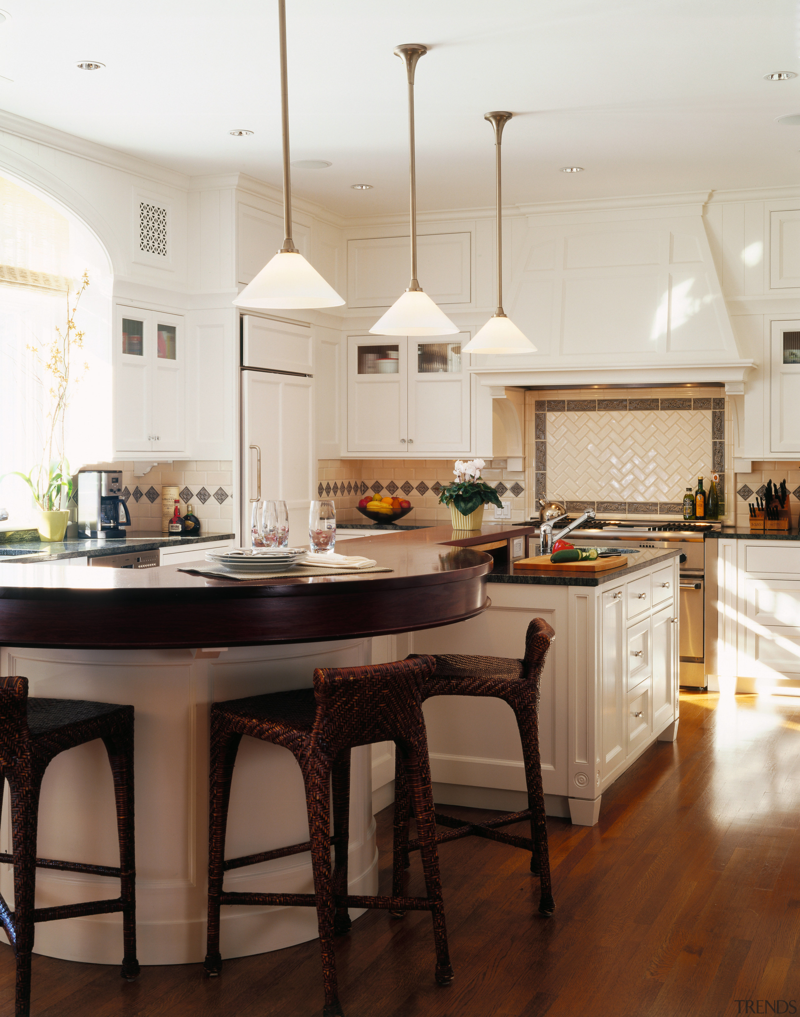 view of the kitchen featuring downlightin, white cabinetry, cabinetry, ceiling, countertop, cuisine classique, dining room, floor, flooring, hardwood, home, interior design, kitchen, laminate flooring, room, wood flooring, white