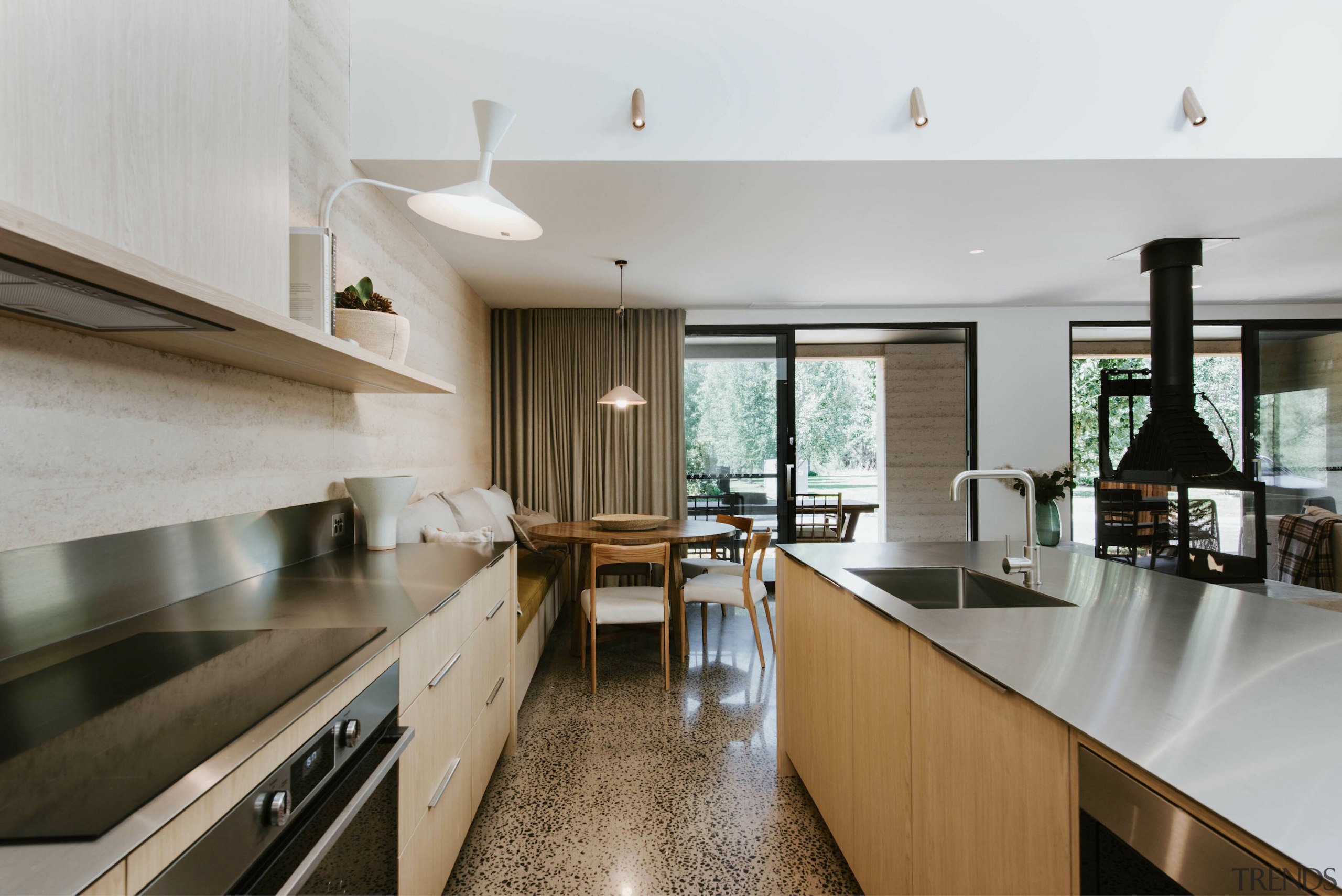 Slender stainless steel benchtops feature on the island 