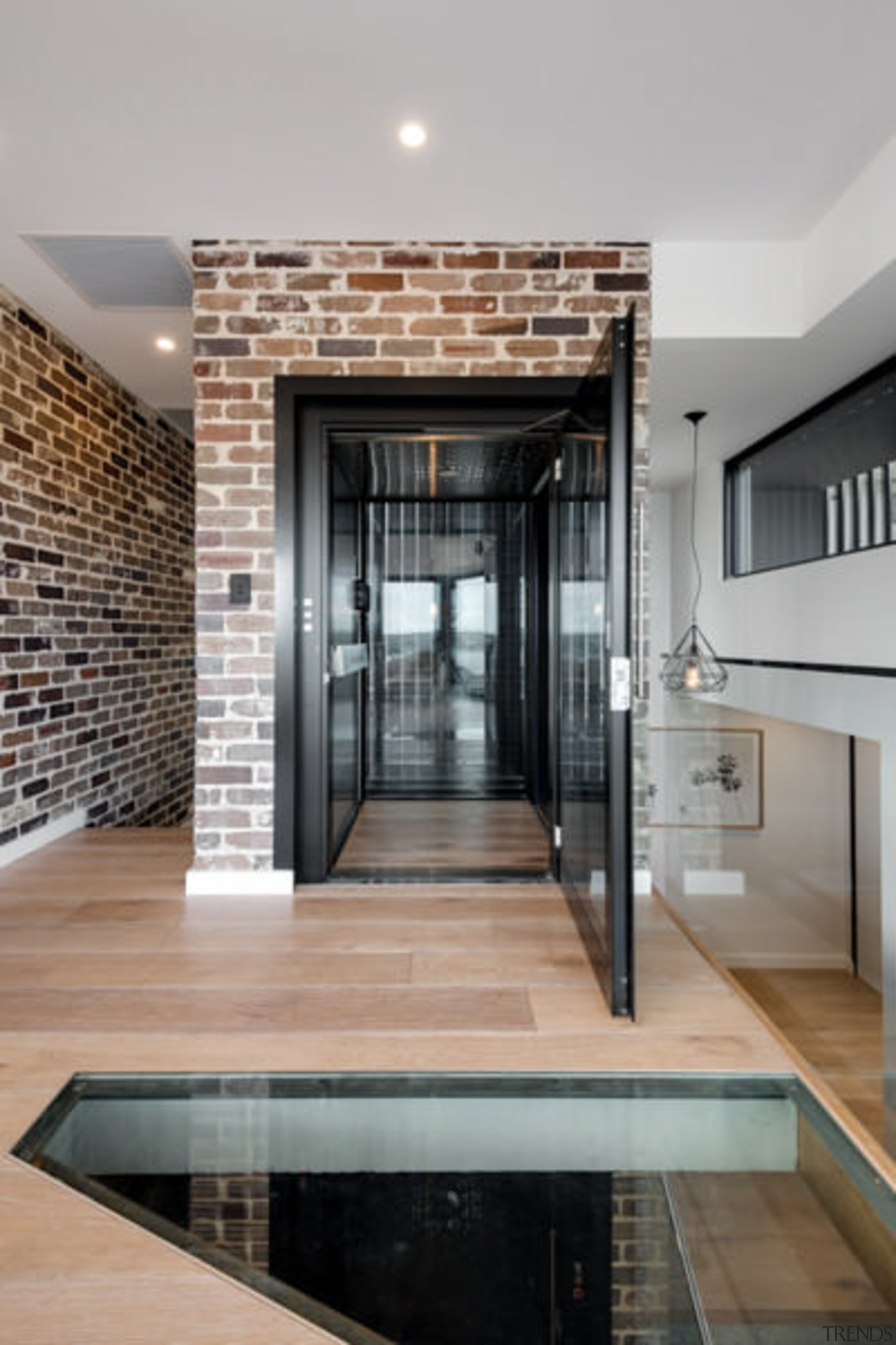 There are almost abstract forms throughout the central door, floor, flooring, interior design, gray