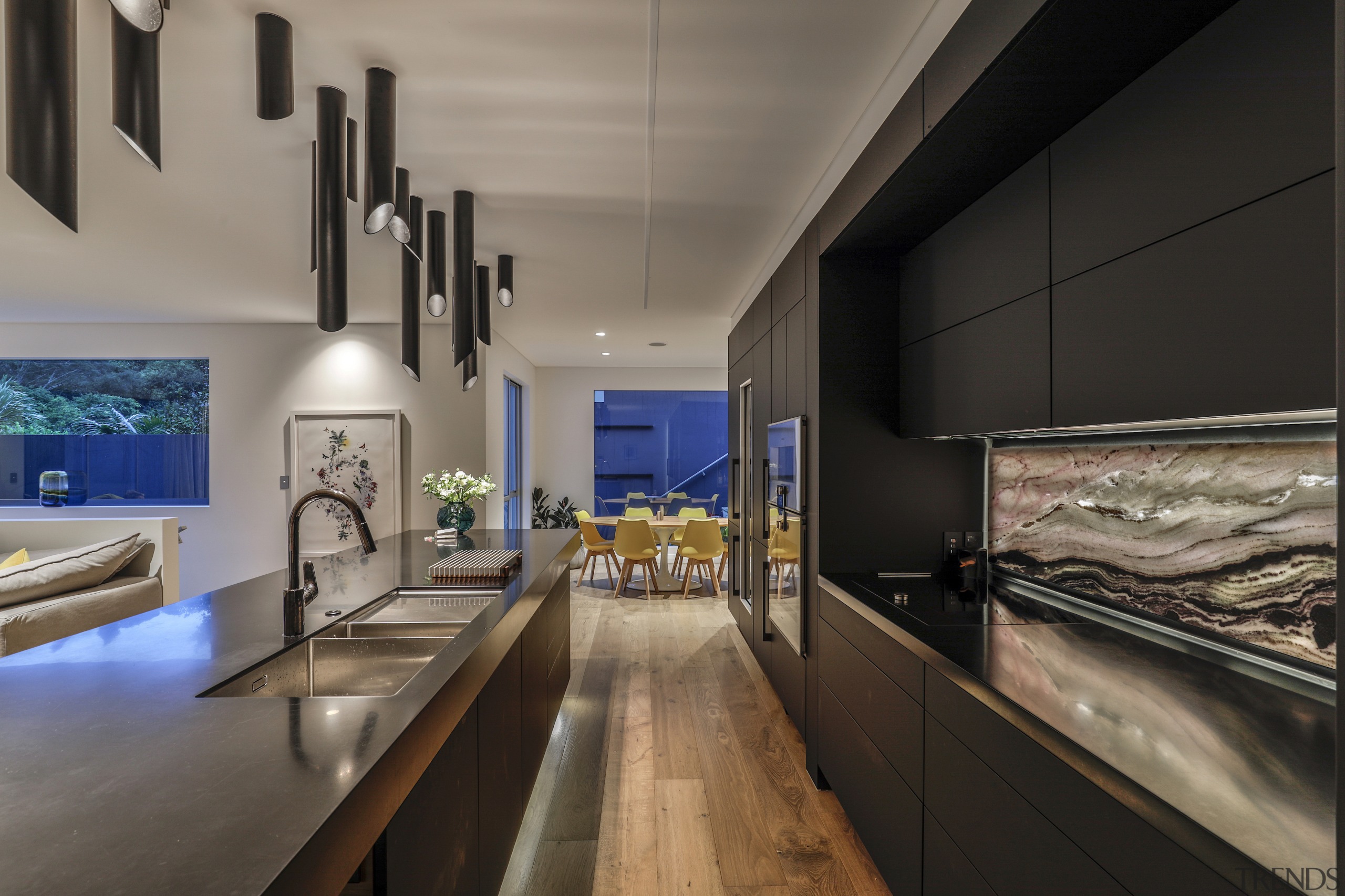 An exotic veined stone splashback offsets the kitchen's 