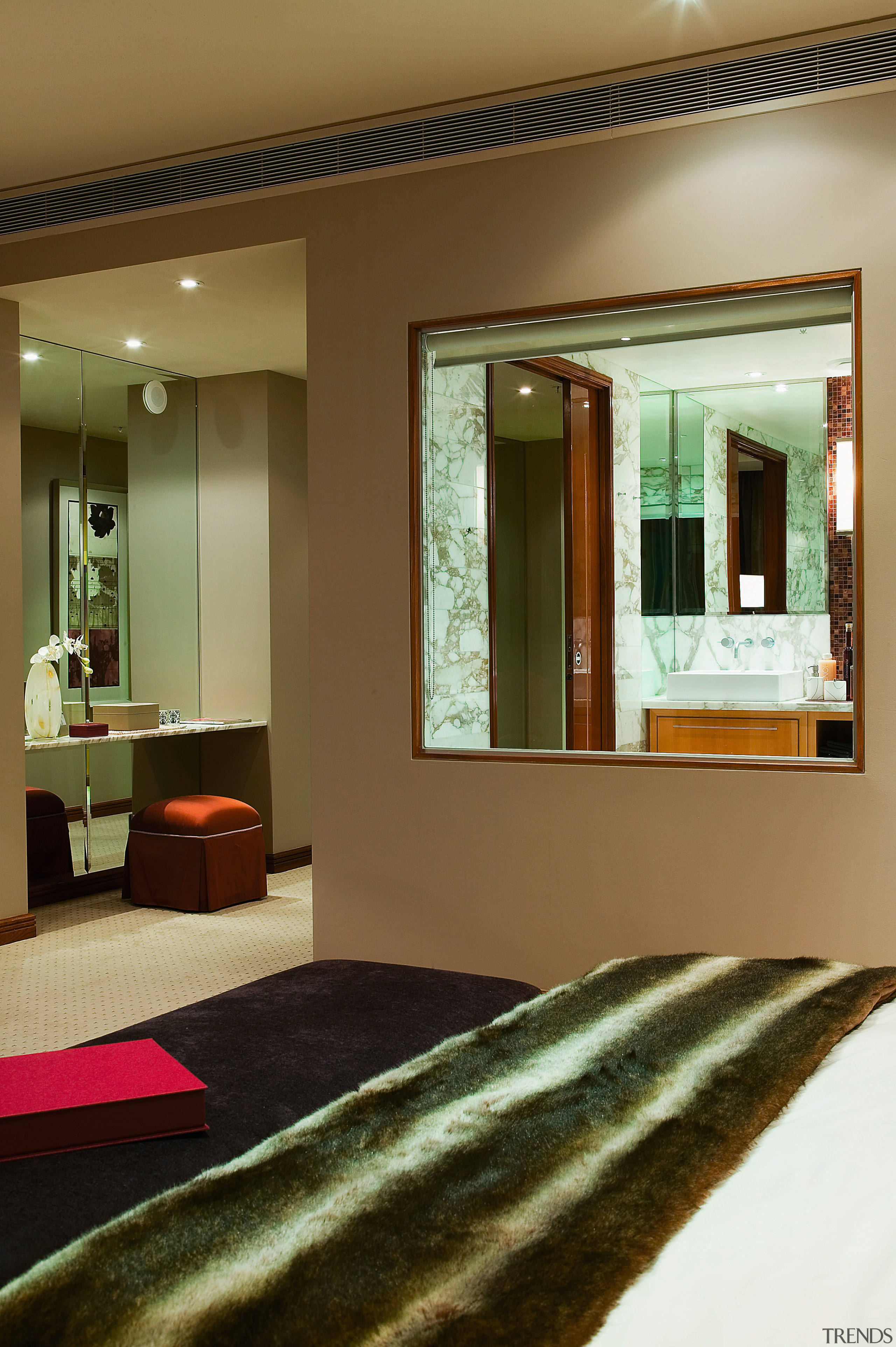 view of the master bedroom featuring red tones, ceiling, door, furniture, interior design, room, window, brown