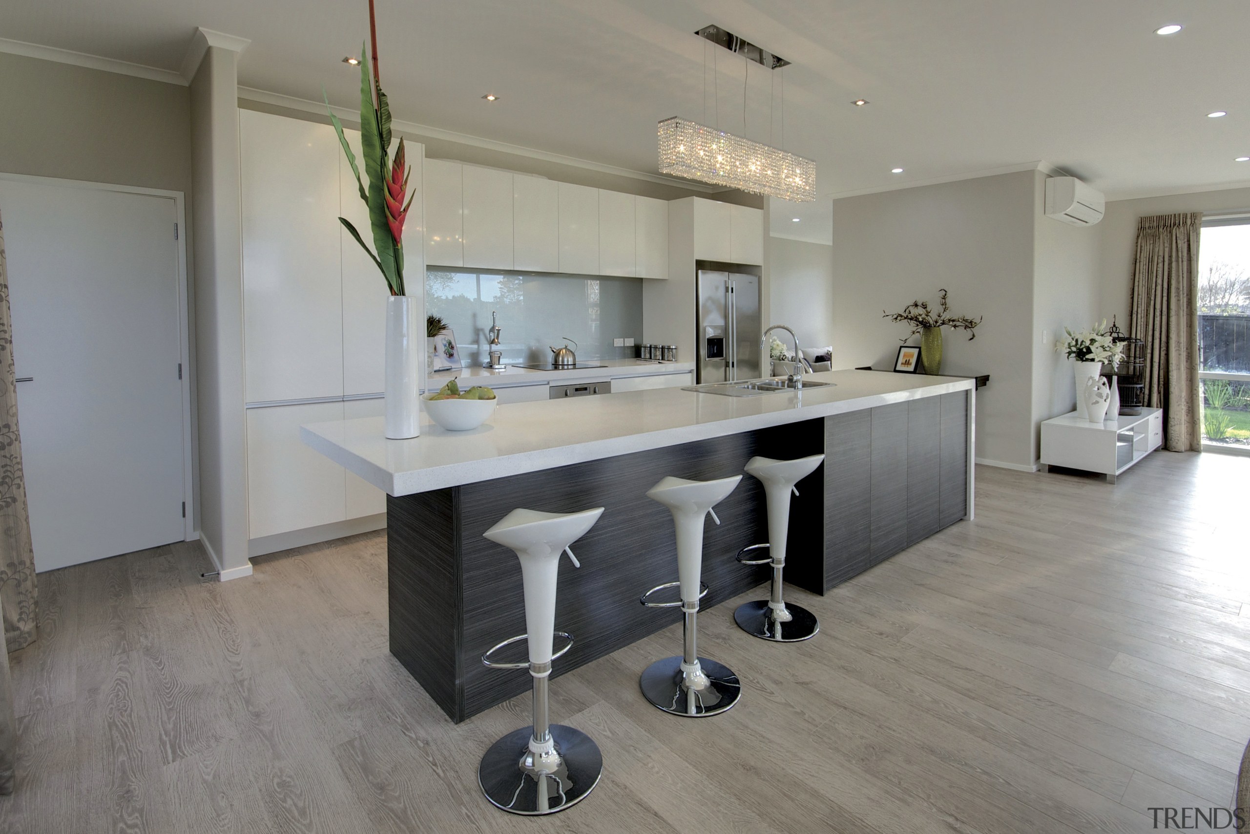 kitchen with bar seating at island. wood floors, countertop, floor, flooring, interior design, kitchen, property, real estate, room, wood flooring, gray