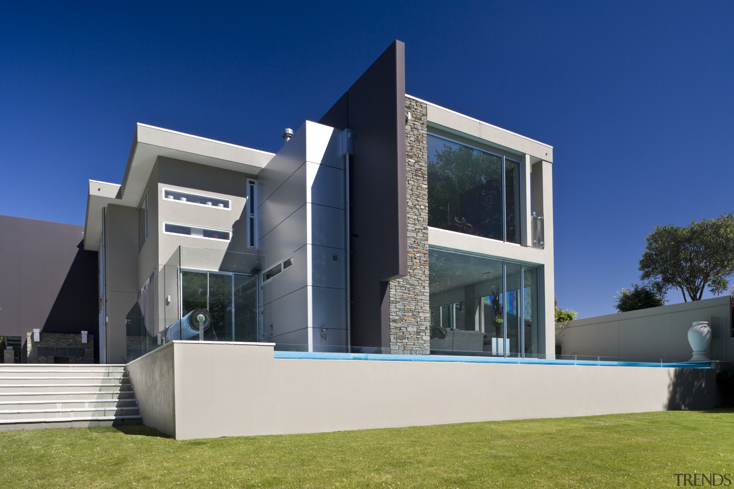 Exterior view of house and pool area with architecture, building, corporate headquarters, daytime, elevation, facade, home, house, property, real estate, sky, blue