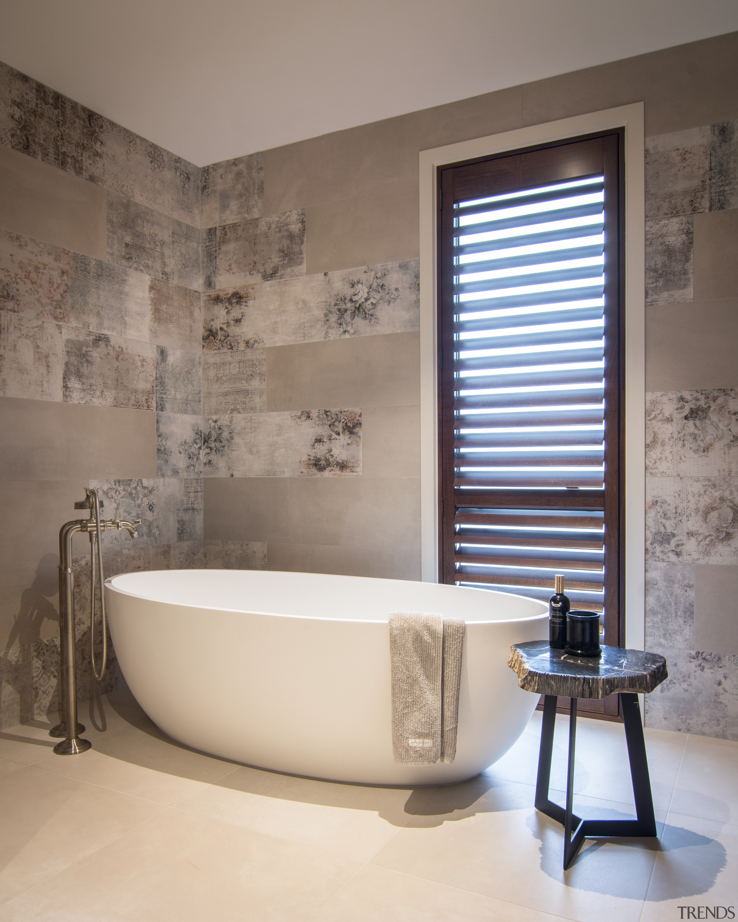 ​​​​​​​Large, distressed-look wall tiles add to the sense 