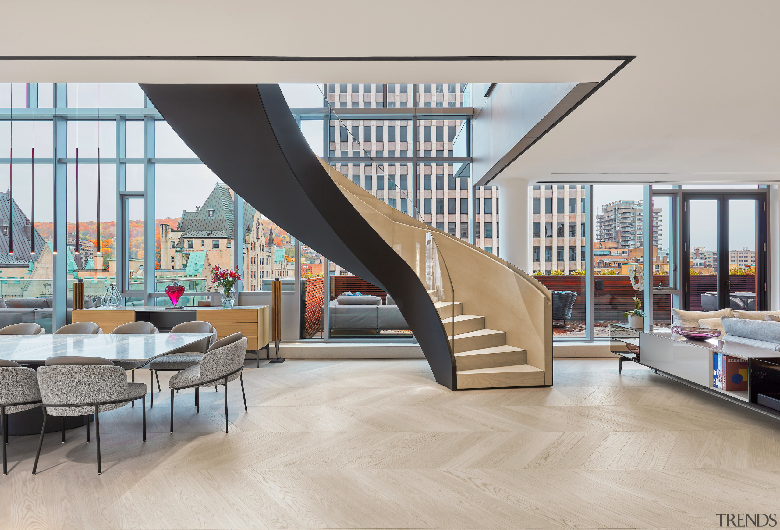 The stairs ascend between the dining and living 