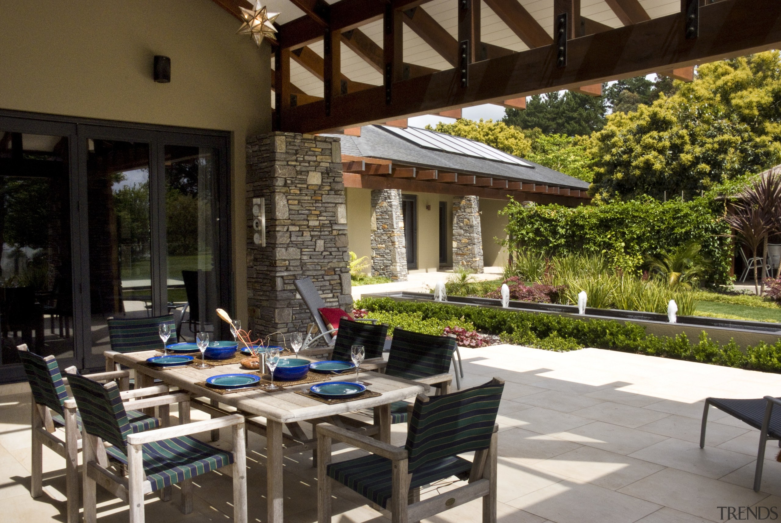 View of the patio area which features outdoor backyard, courtyard, outdoor structure, patio, table, brown, black