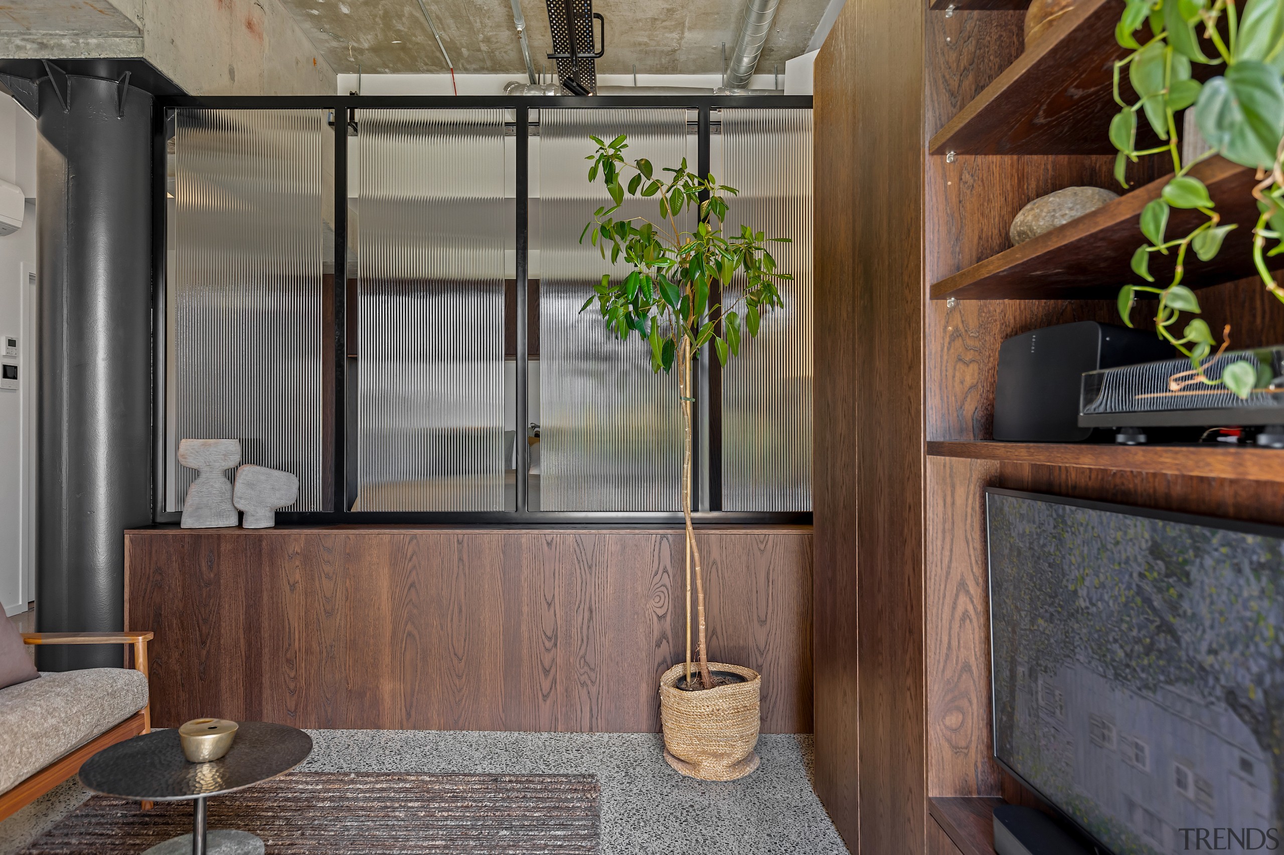 The interplay between warm timber, textured glass, and 