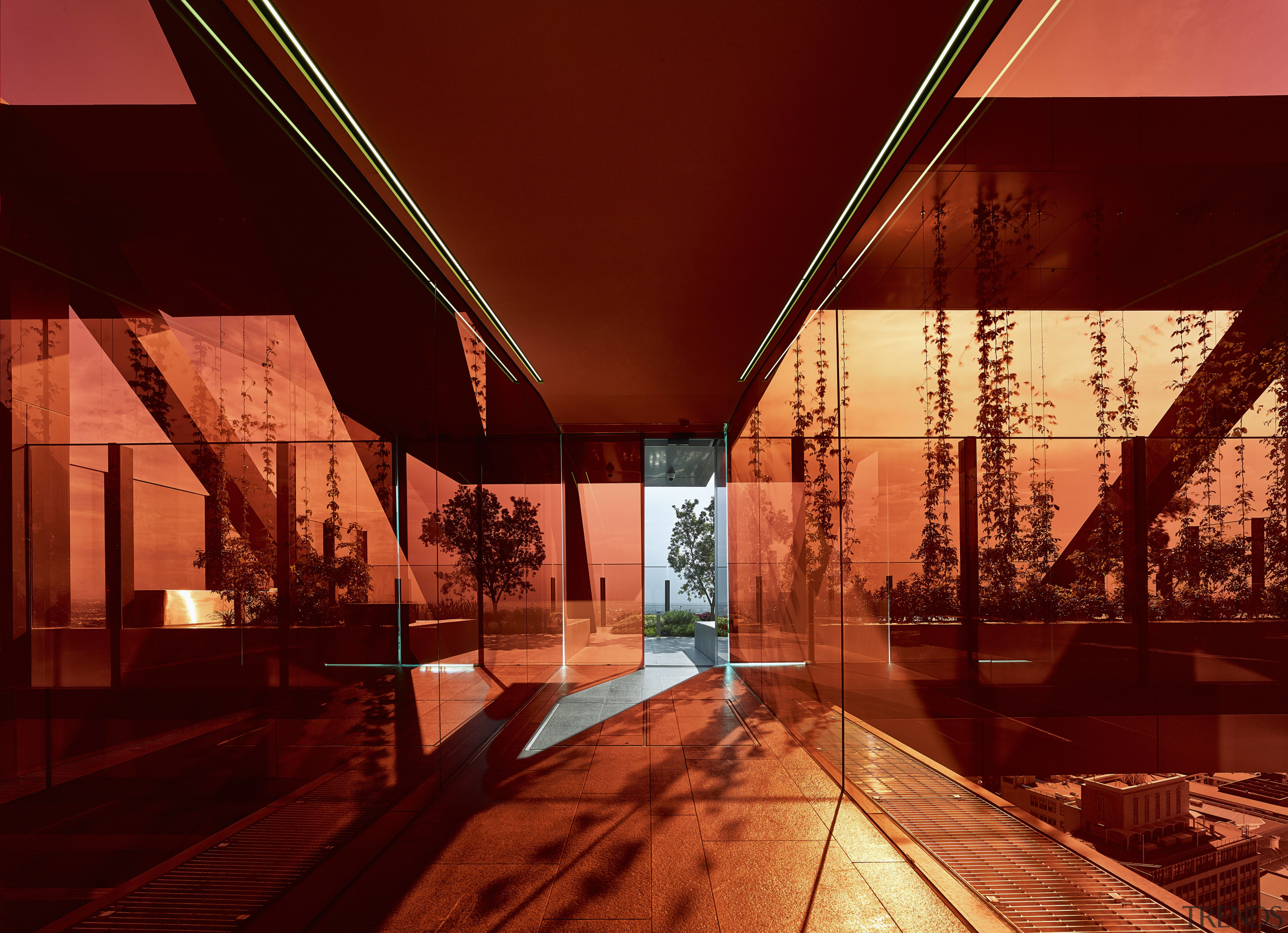 An orange-red glass box forms a transition zone architecture, evening, home, light, lighting, night, reflection, sky, tourist attraction, wood, red