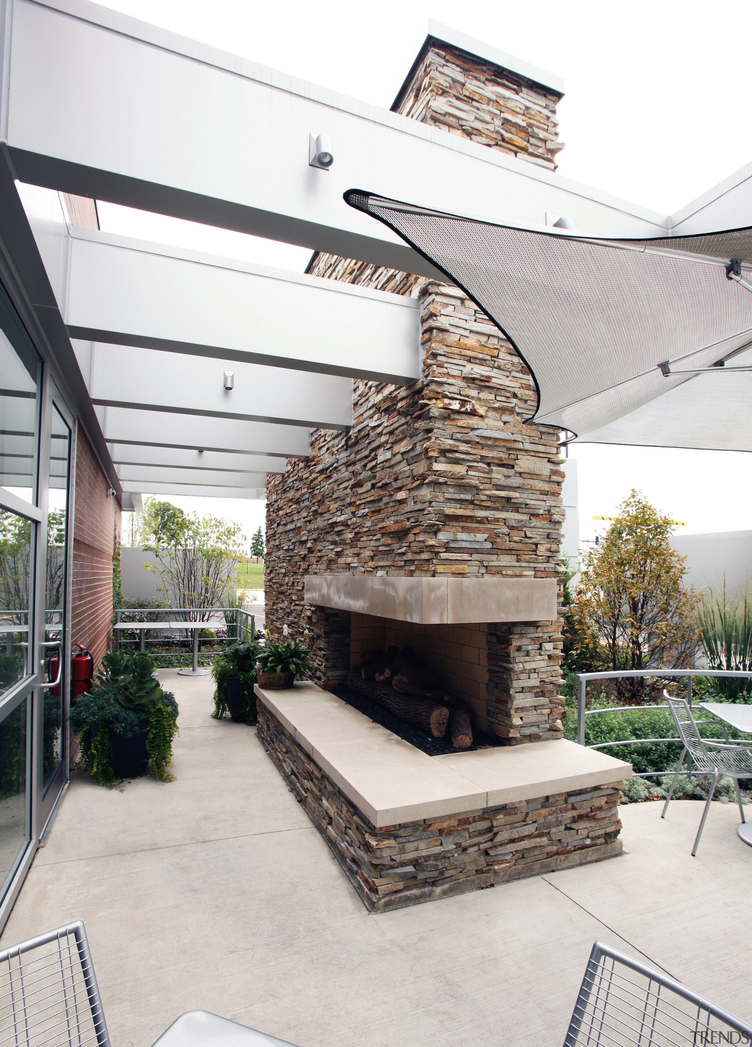 A wall of natural stone has a  rugged architecture, outdoor structure, patio, white