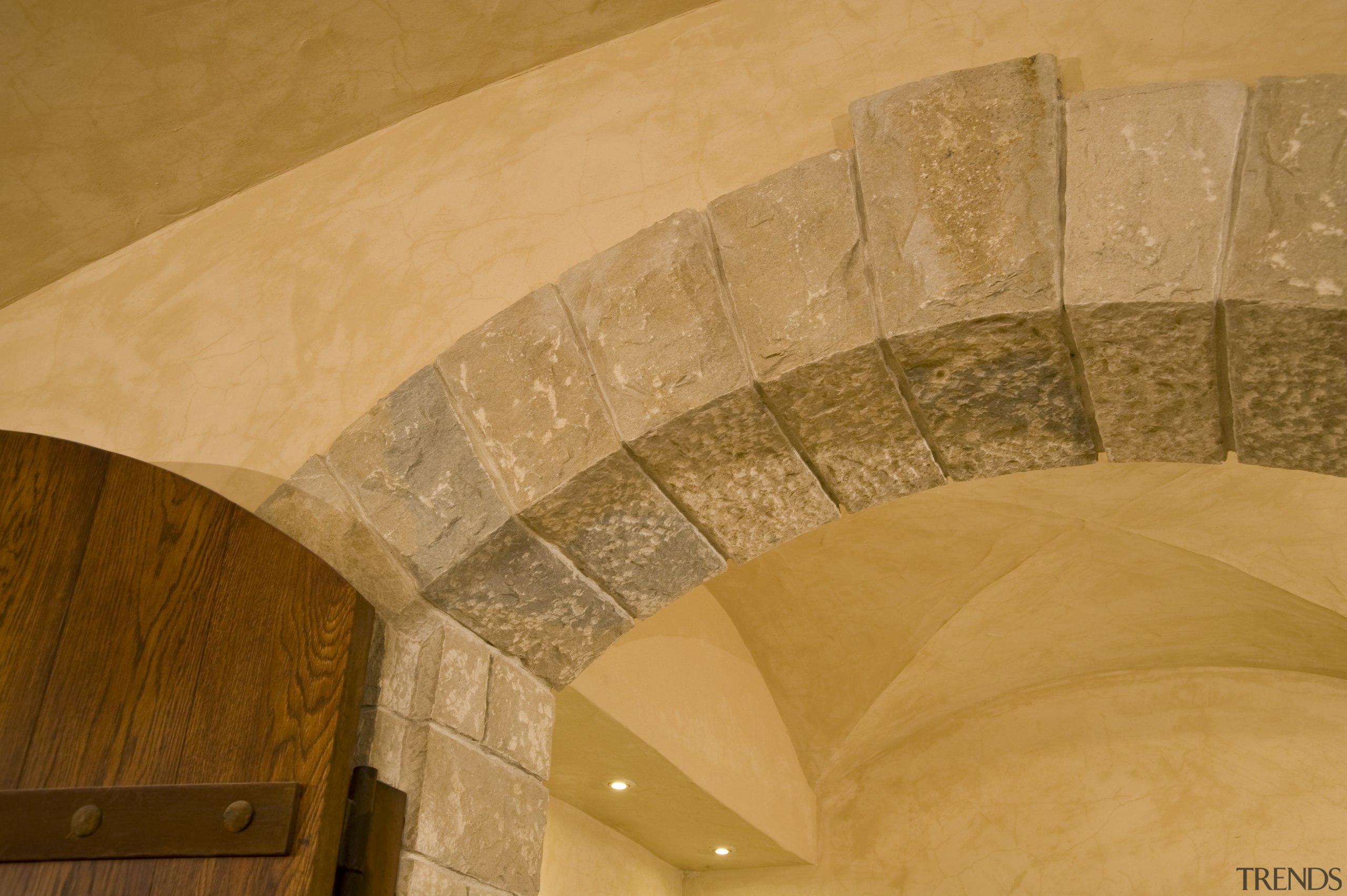 View of a wine cellar which features limestone arch, architecture, ceiling, daylighting, floor, plaster, wall, orange