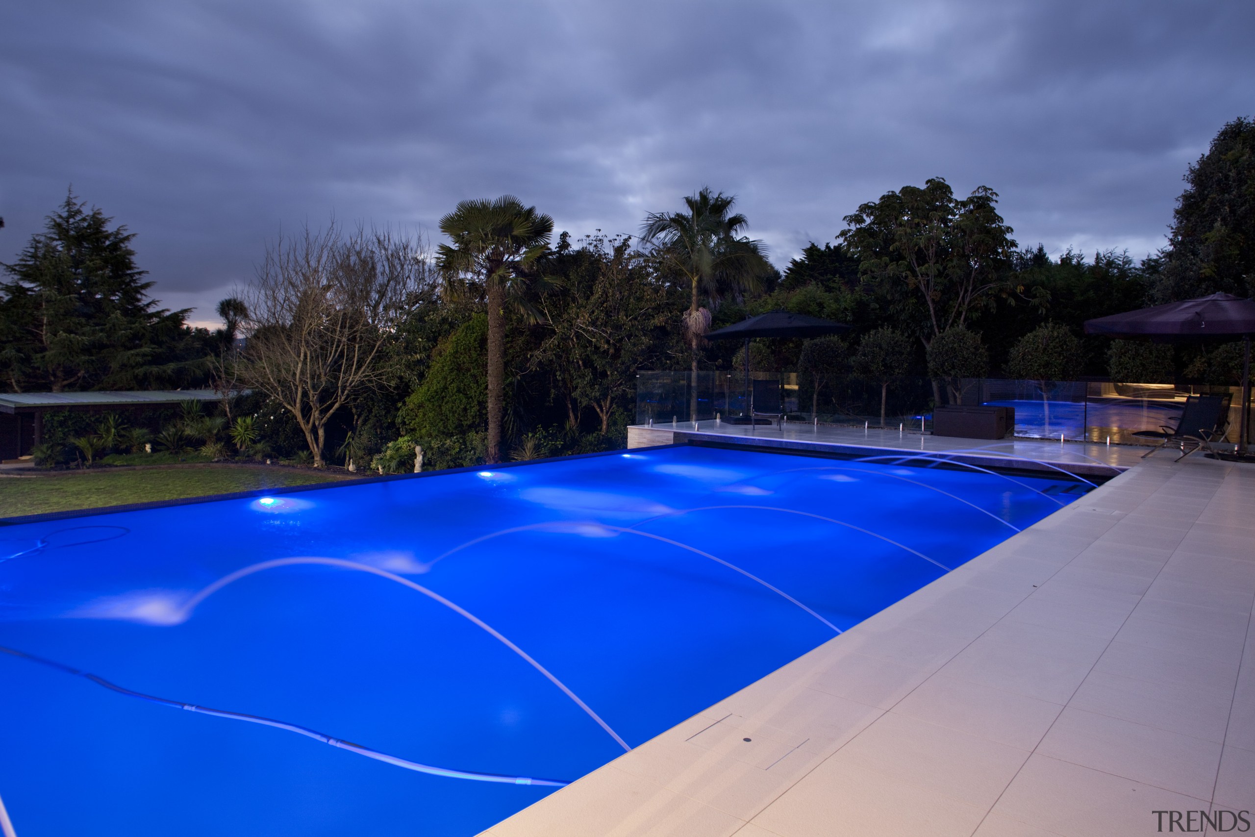 This home was designed by Thomas Errington of area, blue, leisure, lighting, real estate, reflection, sky, swimming pool, tree, water, blue