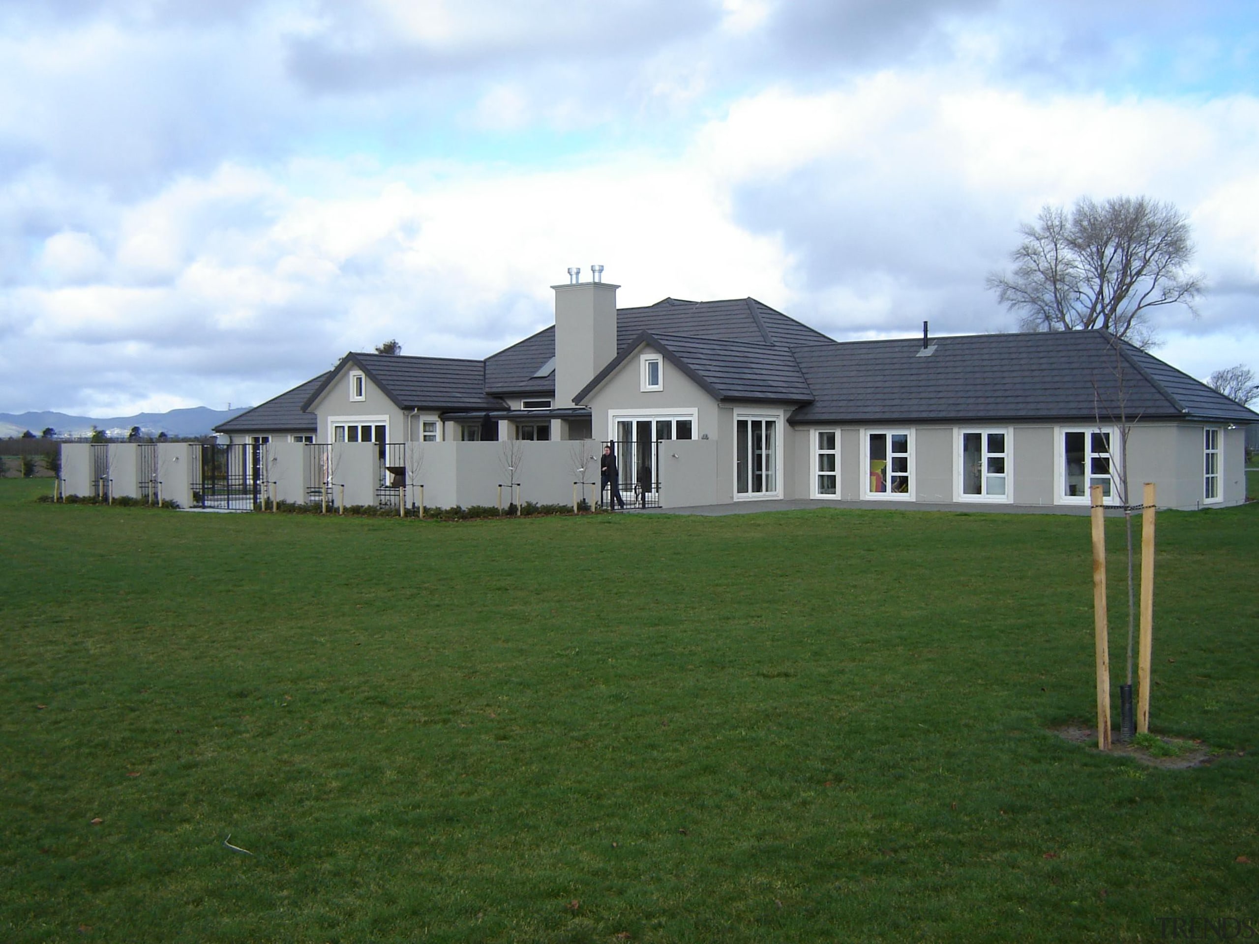 Generously proportioned plaster home built in Canterbury by cottage, estate, facade, farm, farmhouse, grass, grassland, home, house, land lot, landscape, lawn, pasture, property, real estate, residential area, roof, shed, siding, suburb, yard
