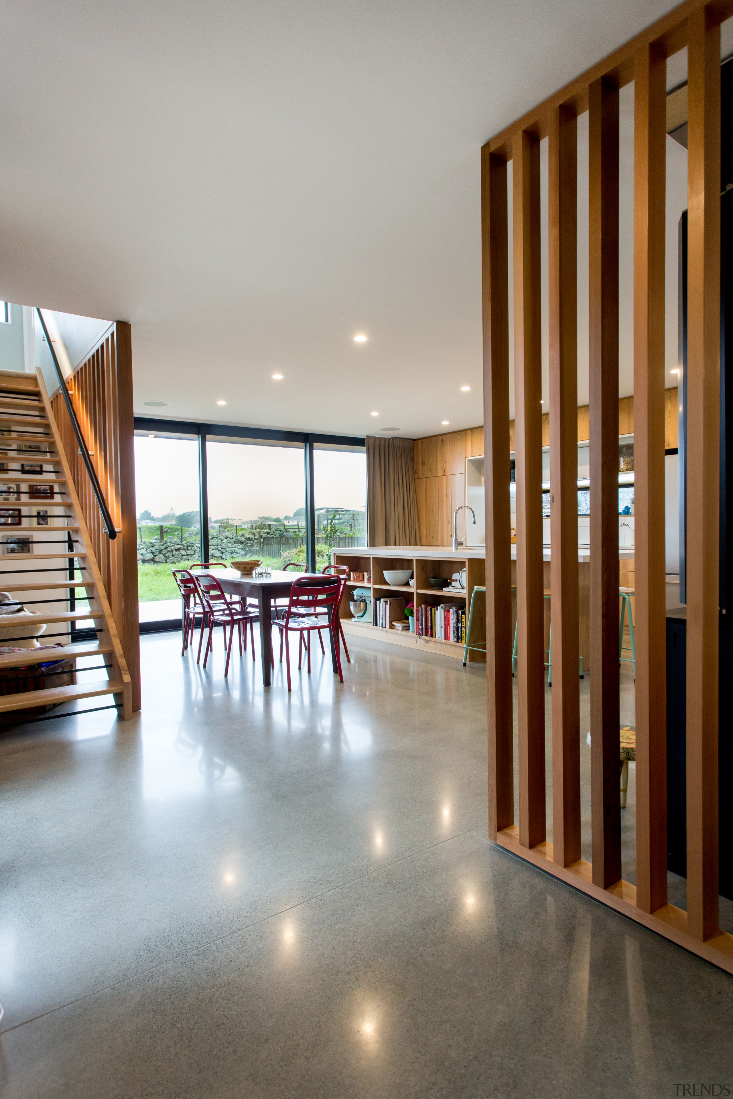 Polished concrete floors soak up the northern winter apartment, architecture, ceiling, estate, floor, flooring, furniture, hardwood, house, interior design, lobby, real estate, wood, wood flooring, gray, brown