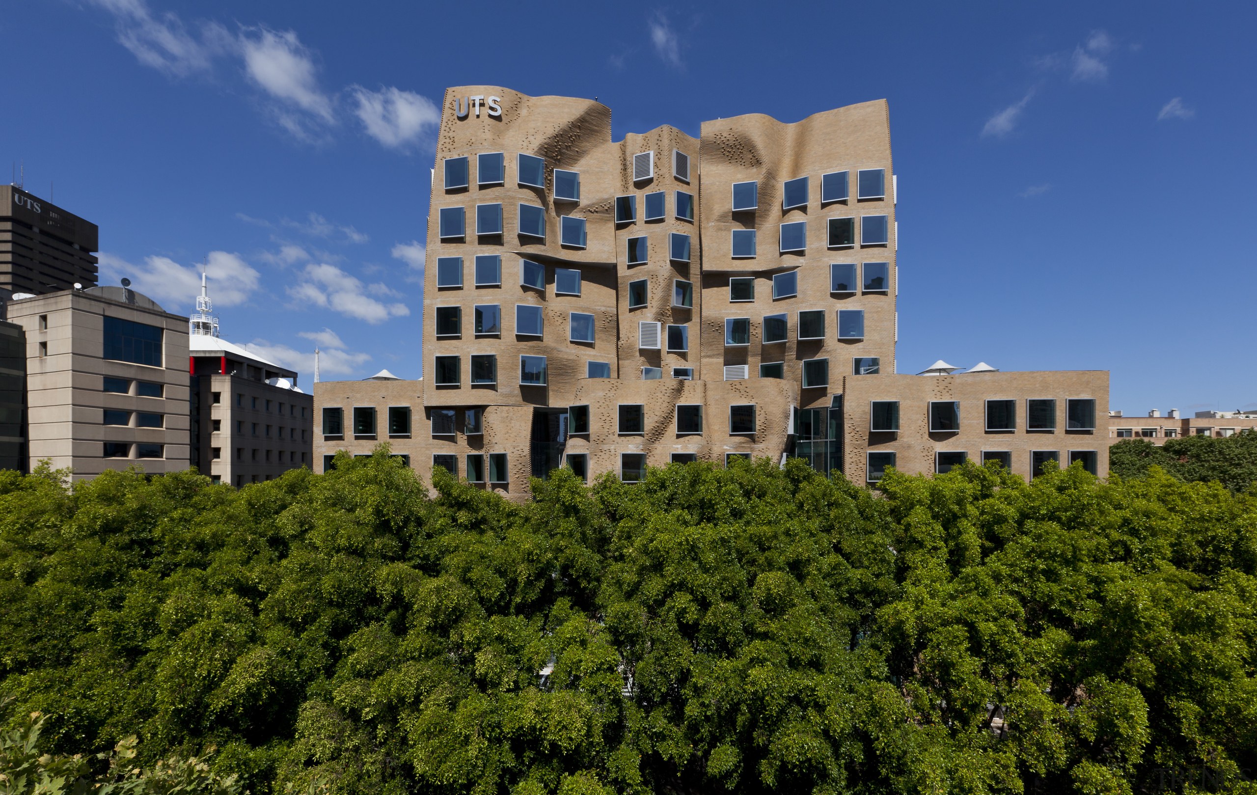 An undulating brick facade features on the Dr apartment, architecture, building, campus, city, condominium, corporate headquarters, daytime, estate, facade, home, house, landmark, mixed use, neighbourhood, real estate, residential area, sky, tower block, tree, urban area, blue, brown