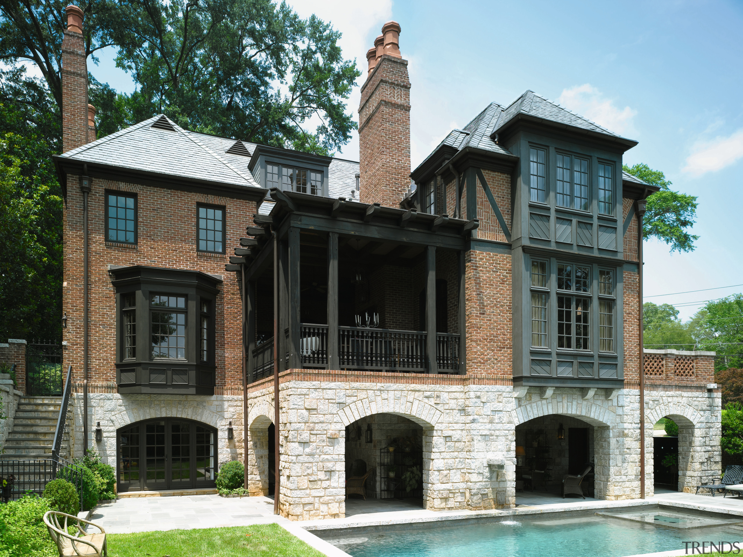 An exterior view of this traditional tudor style building, estate, facade, historic house, home, house, mansion, property, real estate, window, black, white