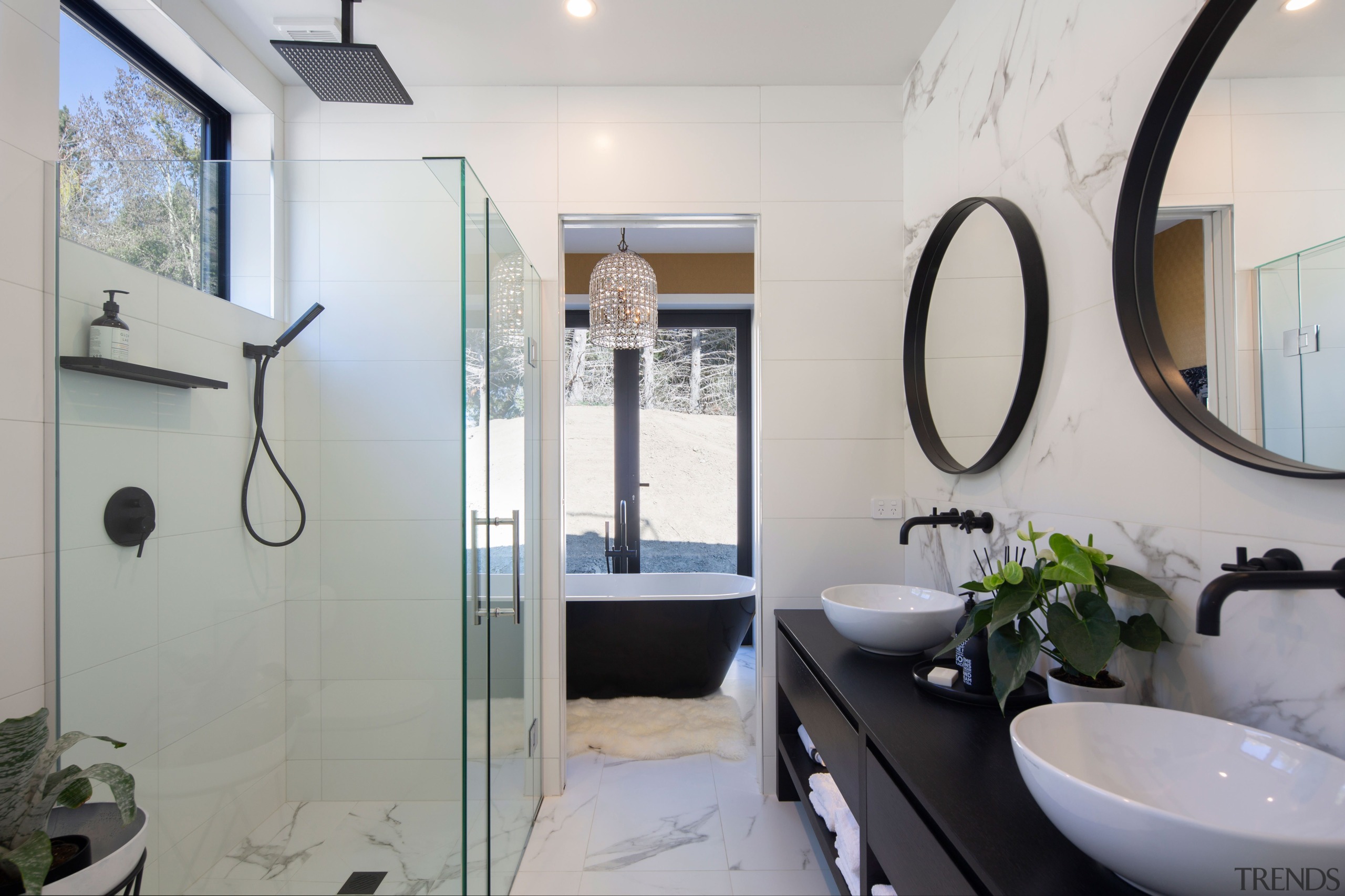 The bathrooms feature marble tiles and matte black 