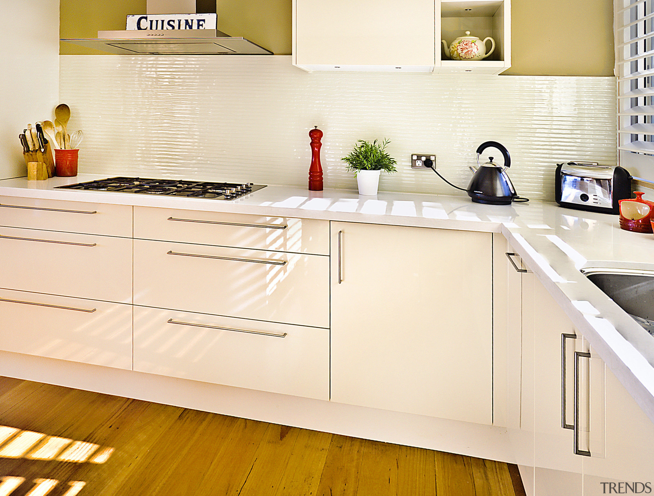 View of kitchen featuring wood floors, white bench cabinetry, countertop, cuisine classique, floor, flooring, hardwood, interior design, kitchen, product design, room, orange