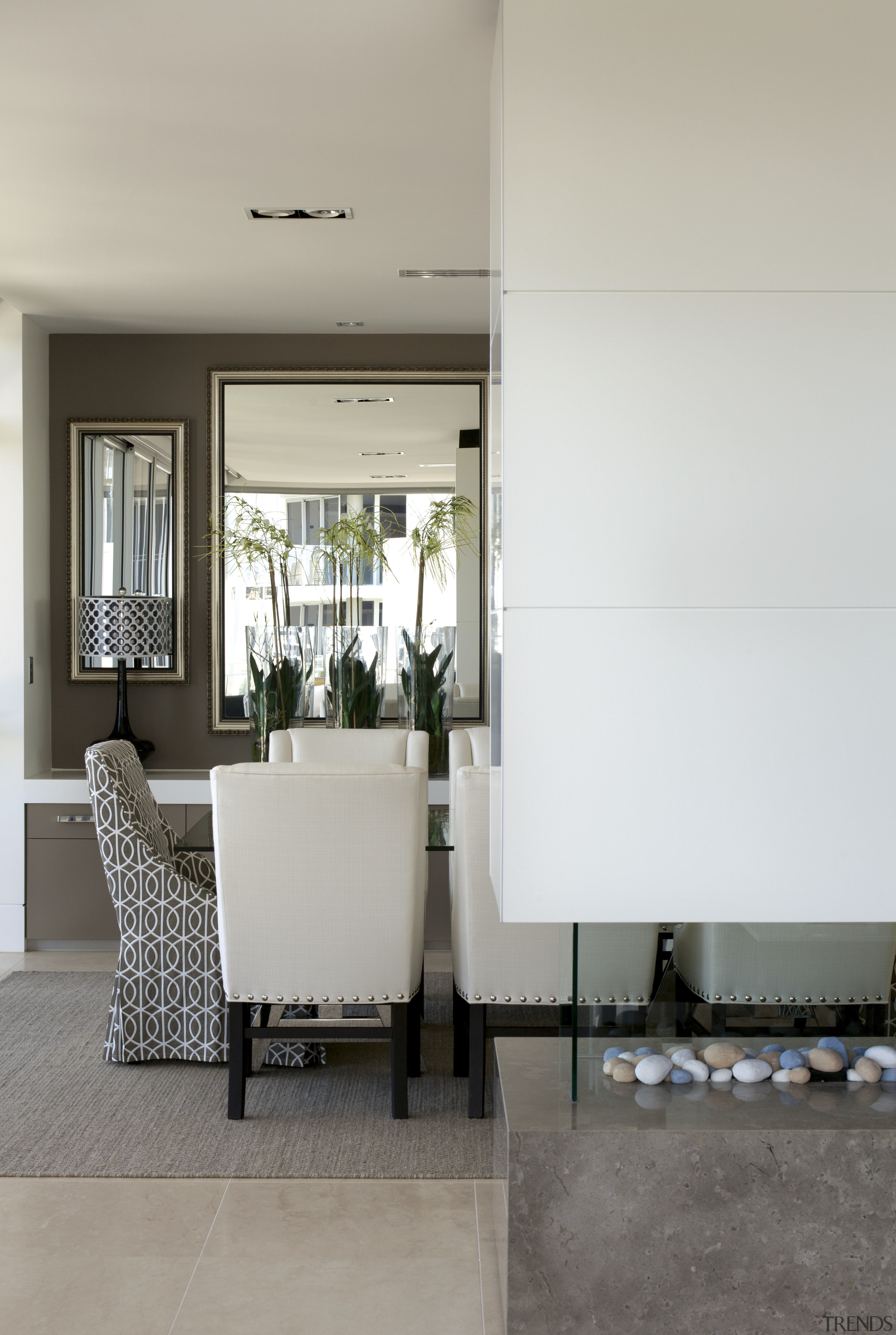 View of white seats in dining area. - floor, flooring, furniture, home, interior design, living room, table, gray, white