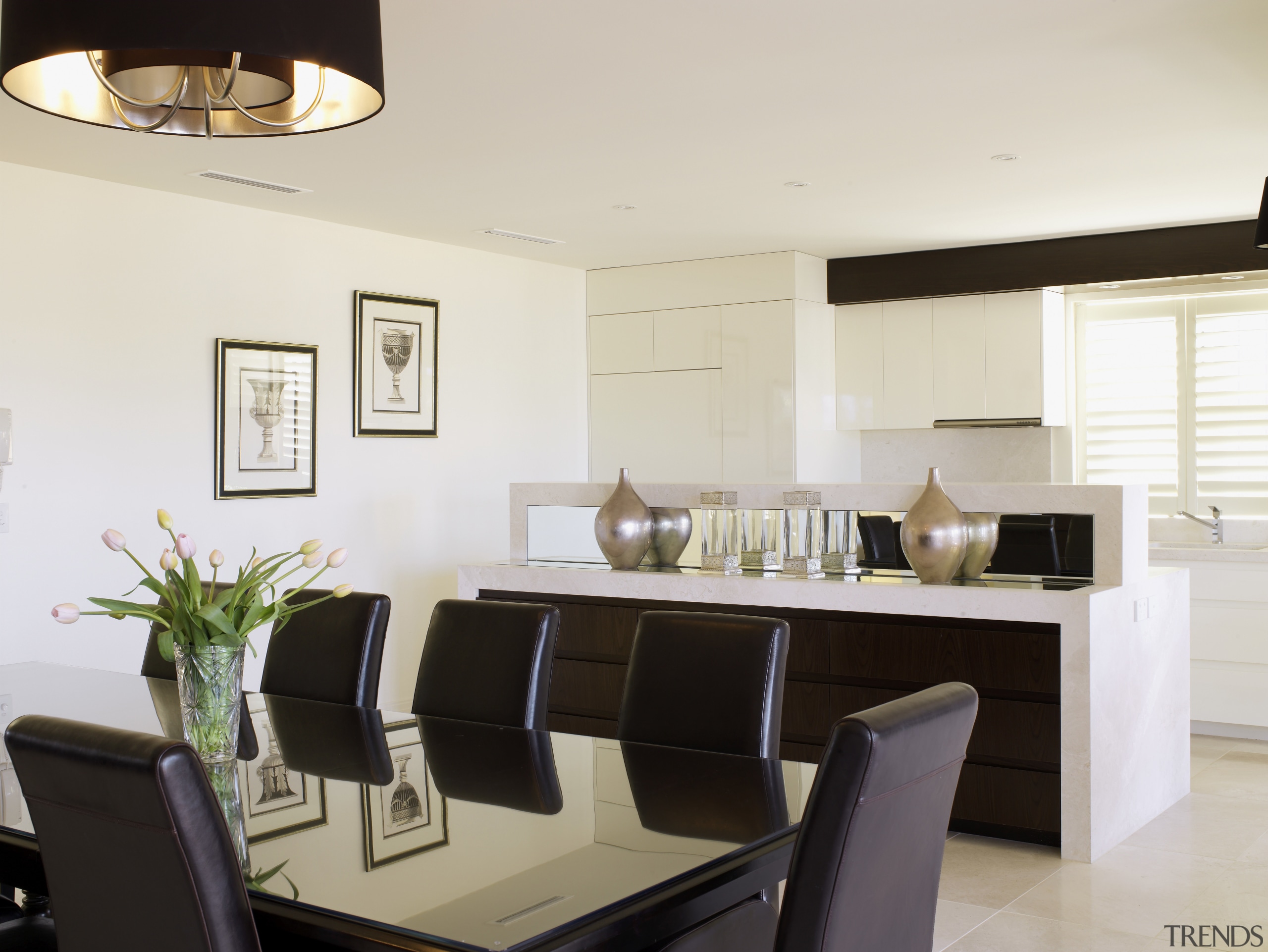 Image of kitchen area which features white cabinetry, dining room, furniture, interior design, kitchen, living room, real estate, room, table, white