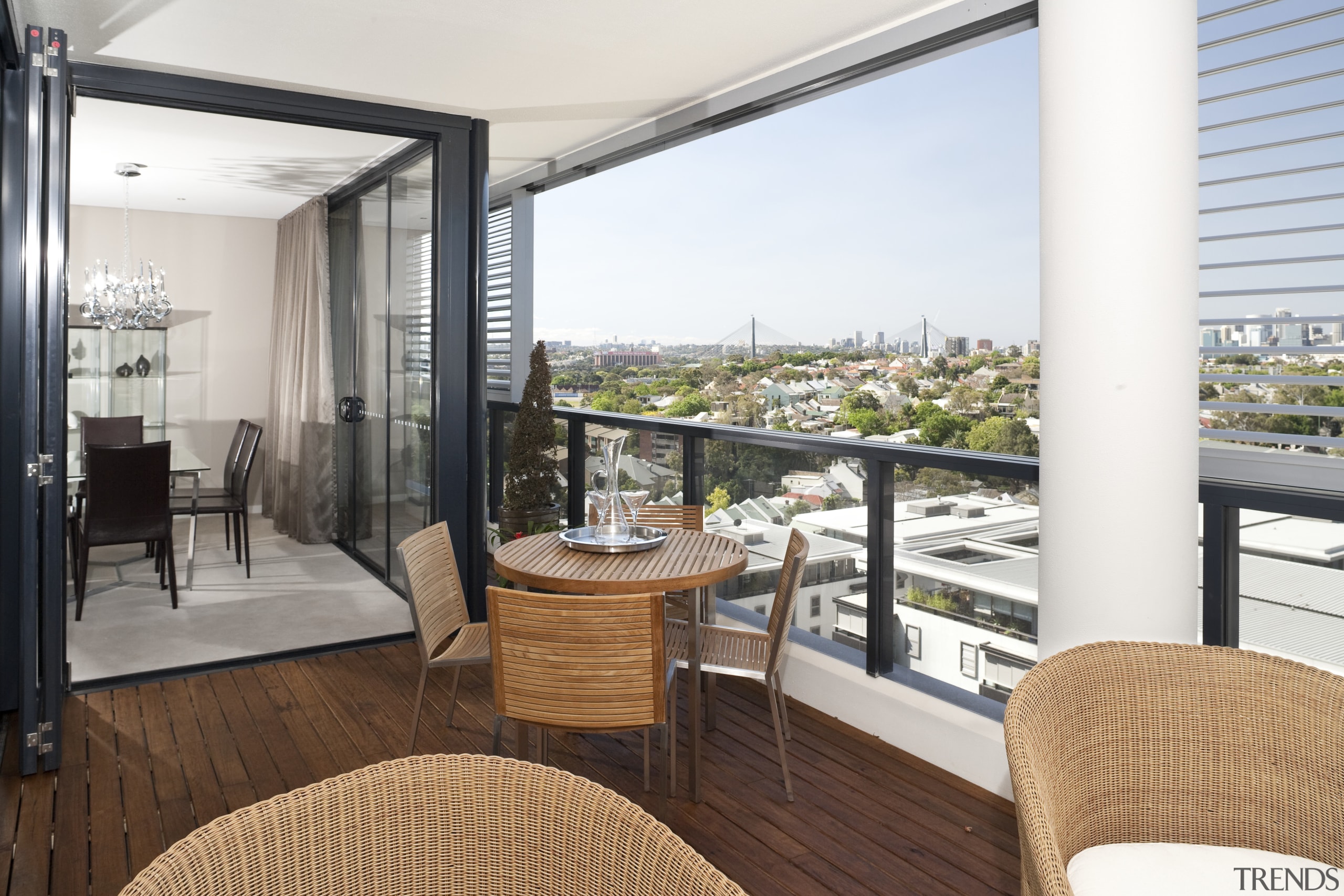 The woven wicker and teak furniture on this apartment, balcony, interior design, penthouse apartment, real estate, room, white