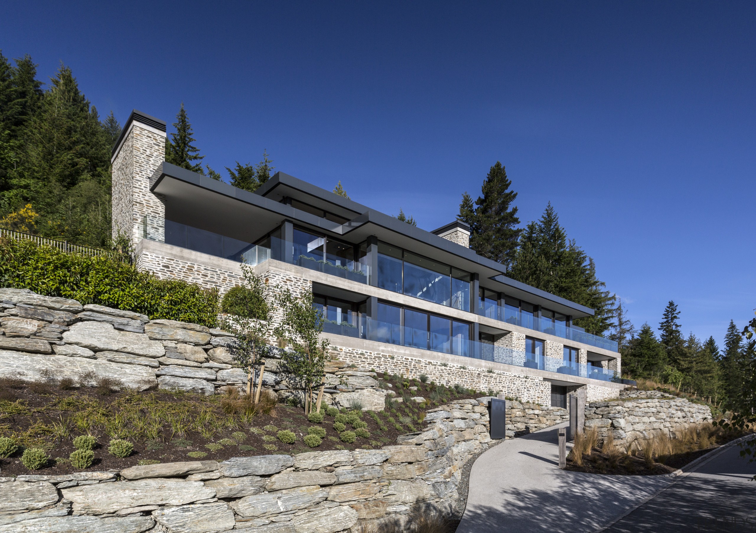 Looking down on Queenstown from on high, this architecture, building, cottage, estate, facade, home, house, mountain, mountain range, property, real estate, sky, villa, blue