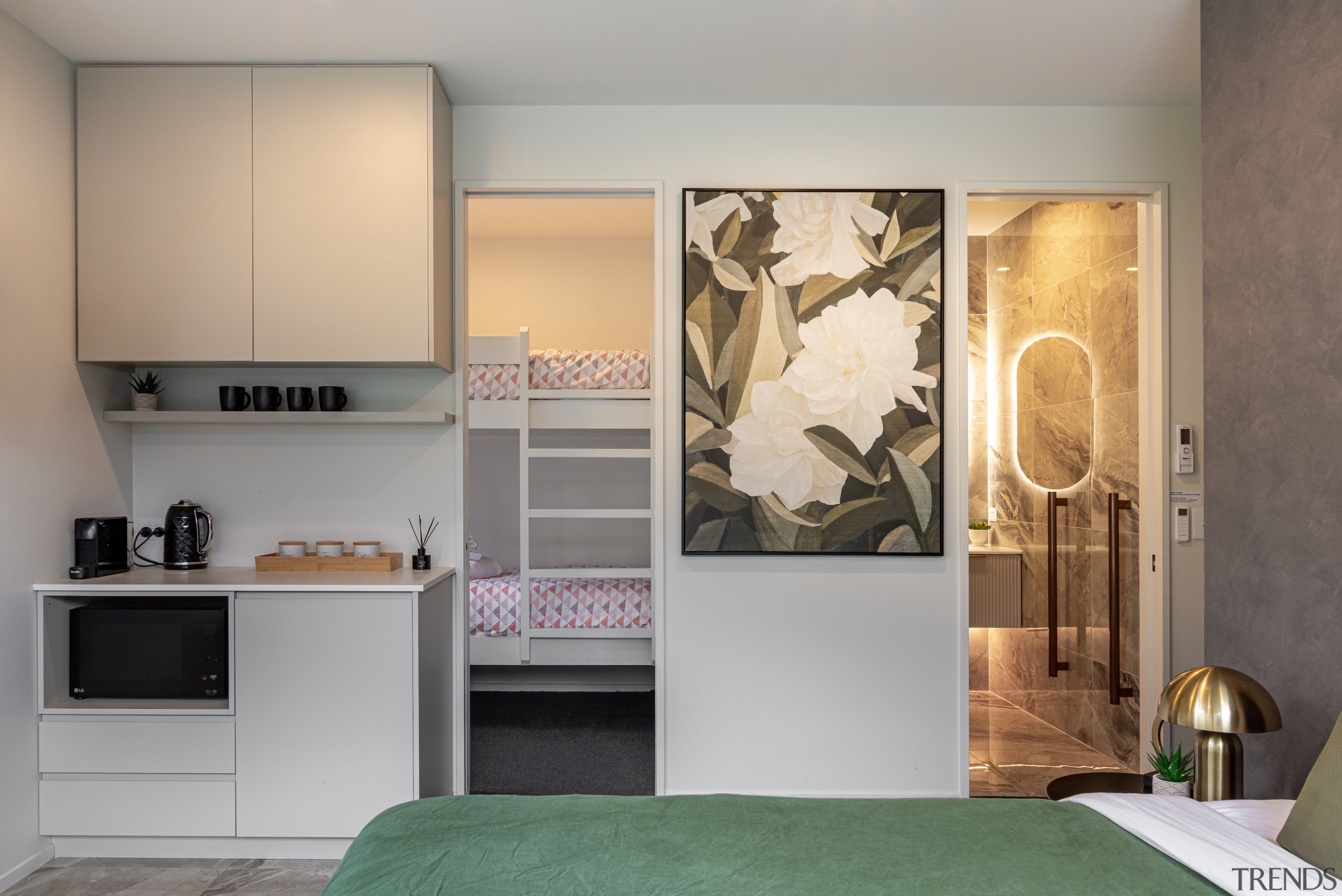 Bedroom with kitchenette and bunk room alongside. 