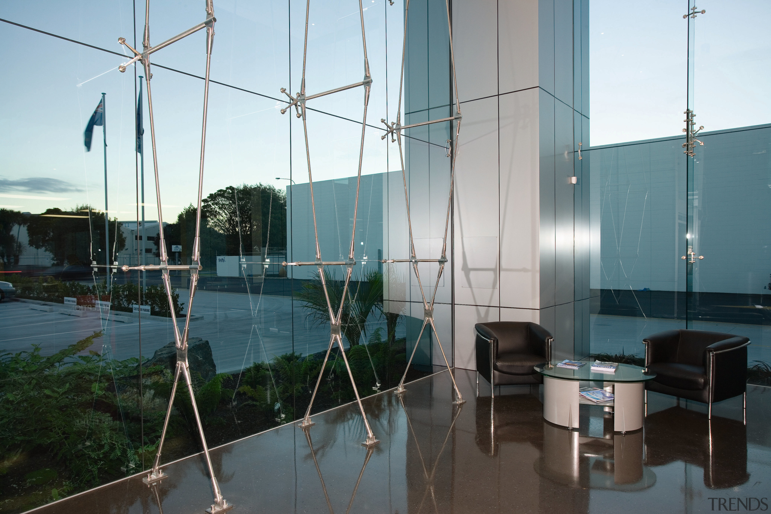 View of extensive glazing in office building, supported glass, reflection, sky, tree, water, white