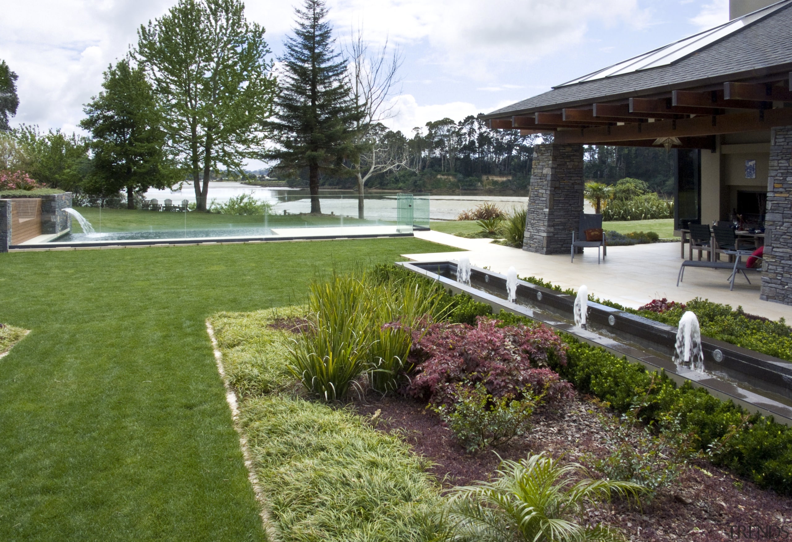 View of the formal pool with four fountains architecture, backyard, estate, garden, grass, home, house, landscape, landscaping, lawn, outdoor structure, plant, real estate, residential area, tree, walkway, yard