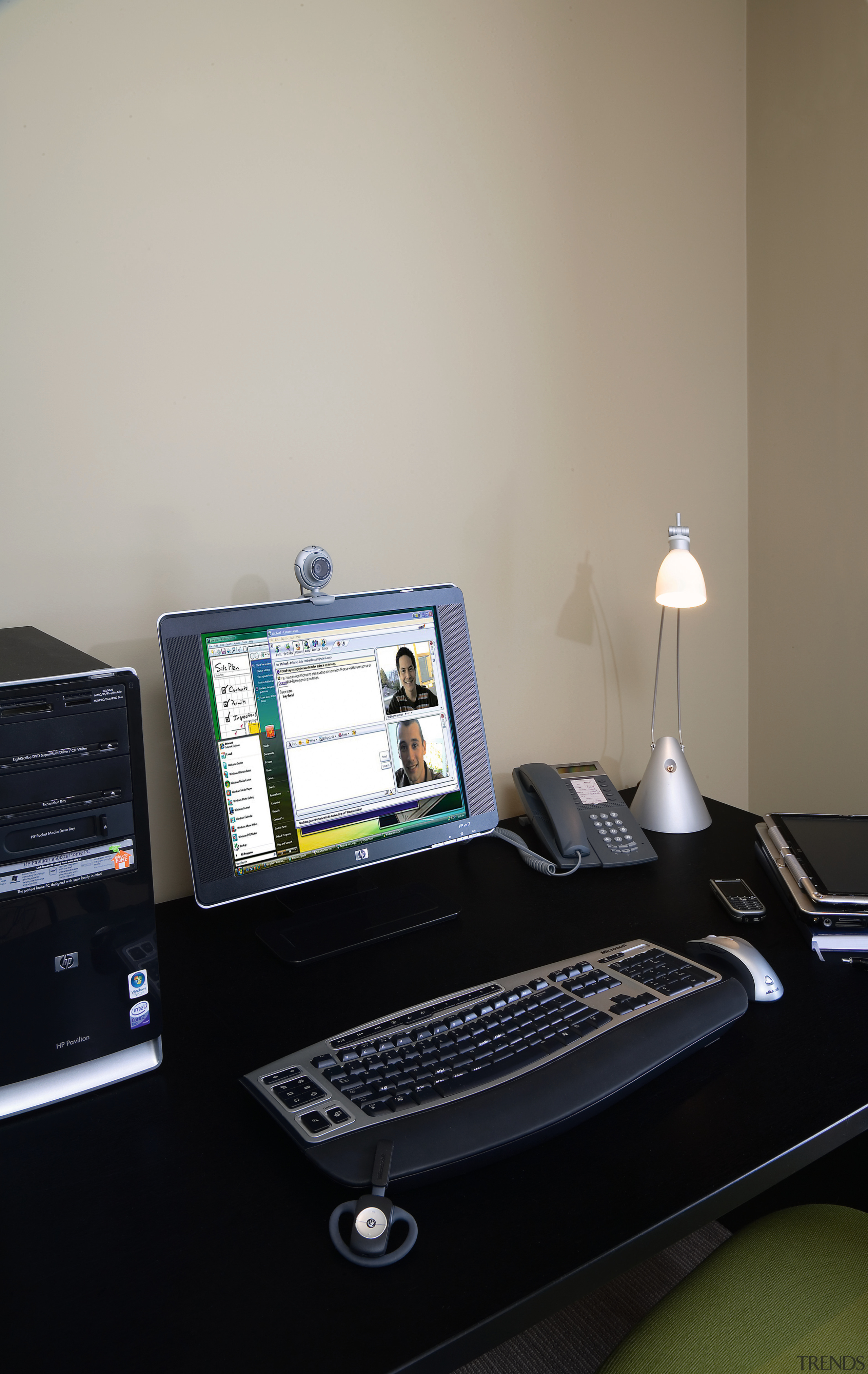 A view of this microsoft computer - A computer hardware, computer keyboard, computer monitor, desk, desktop computer, display device, electronic device, furniture, laptop, office, personal computer, technology, gray, black