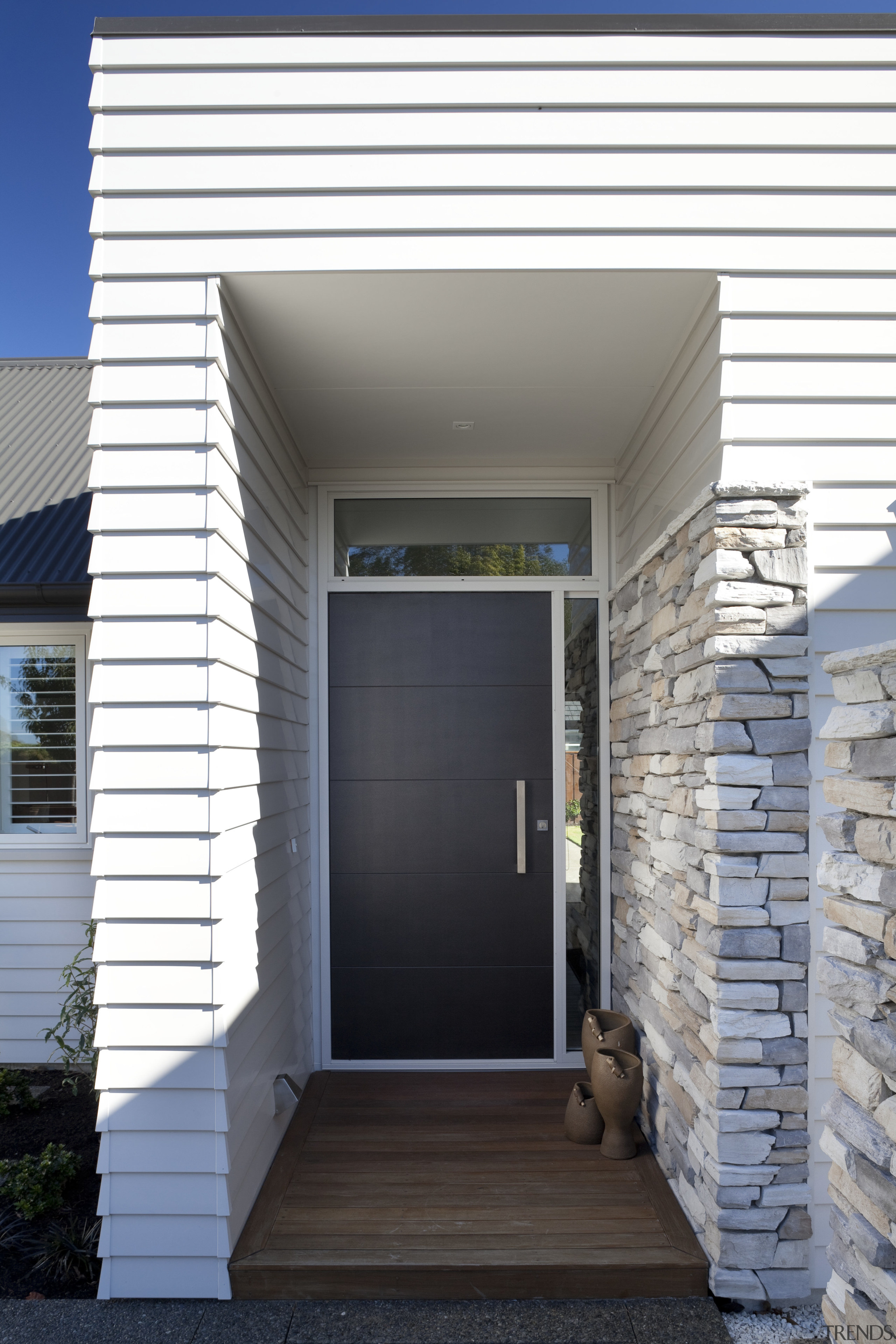 The Palliside weatherboard cladding system provides a clean, architecture, door, facade, home, house, real estate, siding, gray, white