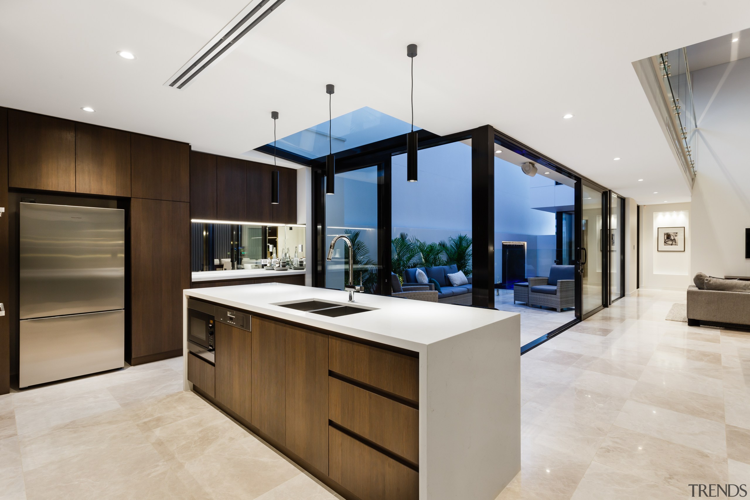 The island with waterfall benchtop in this on-show architecture, cabinetry, countertop, cuisine classique, interior design, kitchen, real estate, white