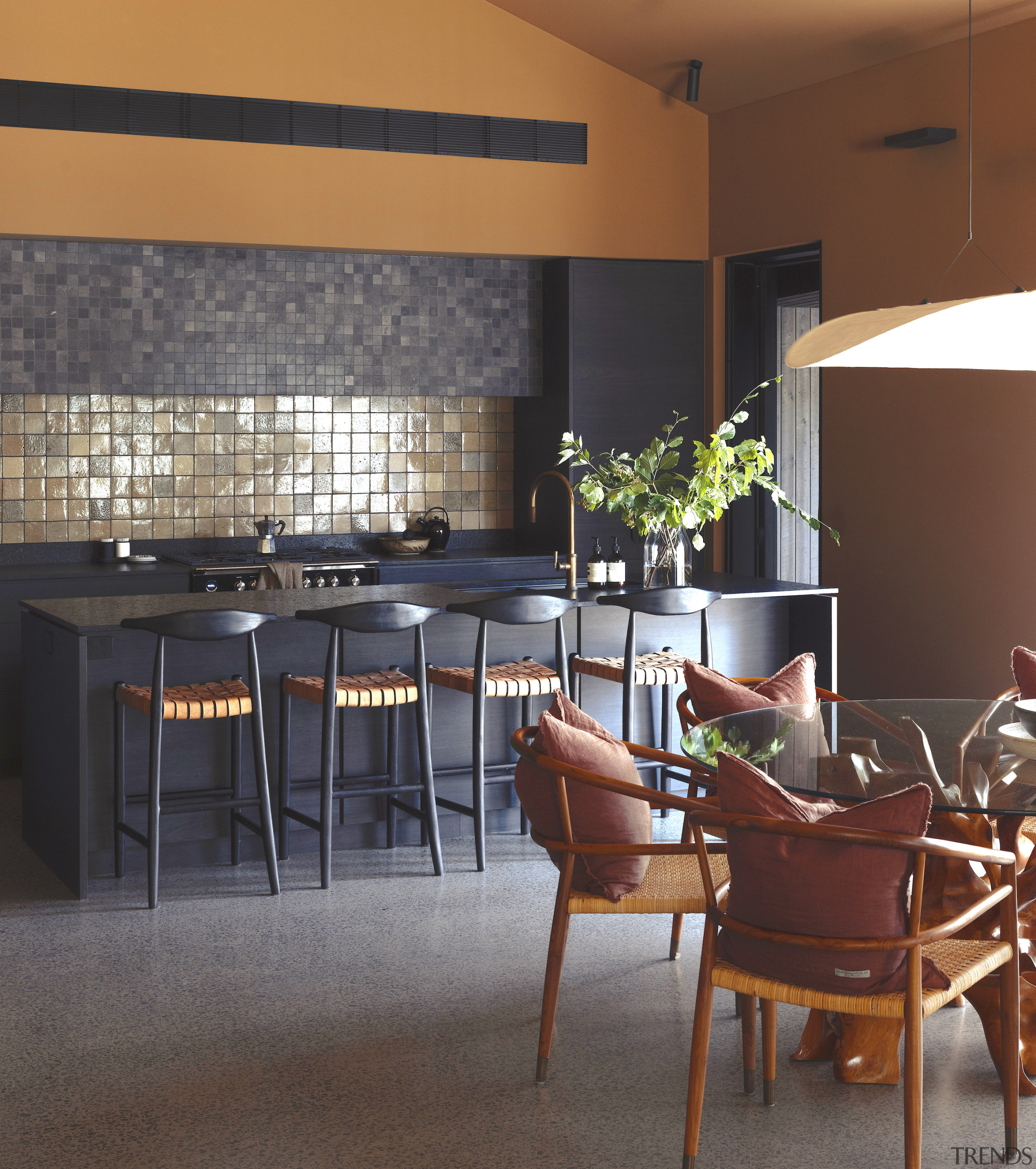 The kitchen's black and tan tones are reflected 