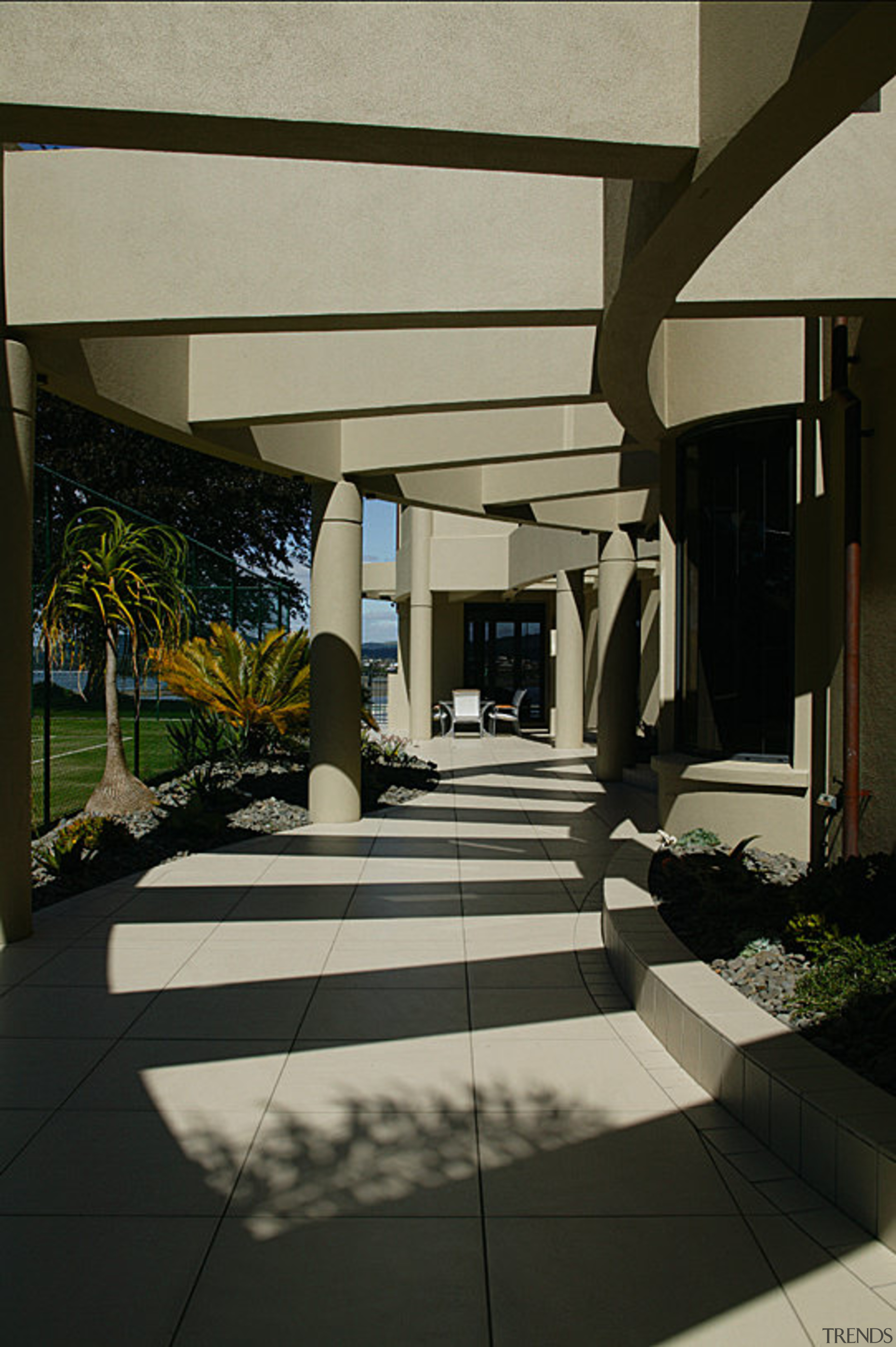 A curved path beneath the pergola which leads architecture, daylighting, floor, house, interior design, structure, table, window, black