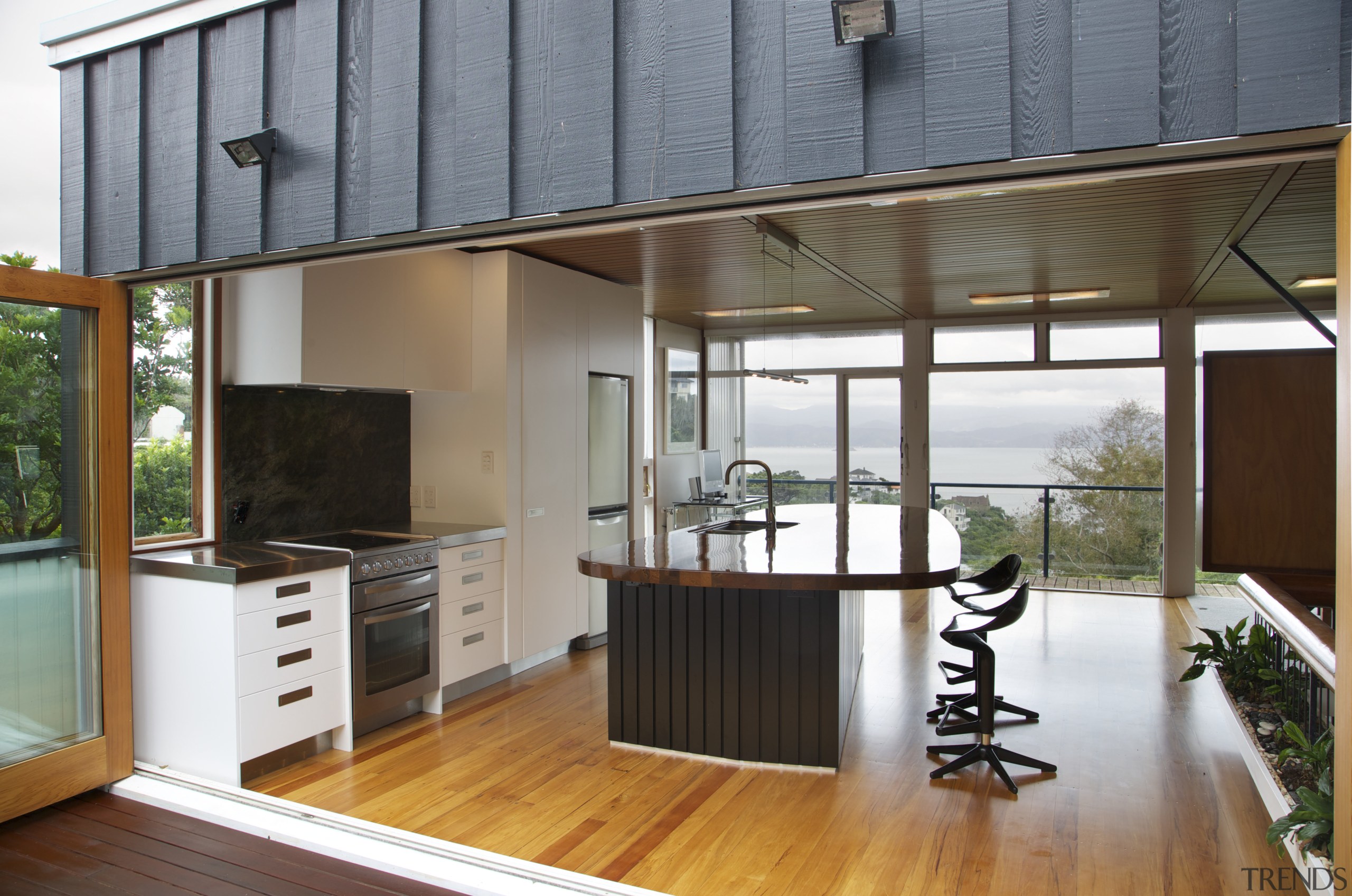 Large bifold doors open up this new kitchen deck, door, house, interior design, real estate, window, gray, brown