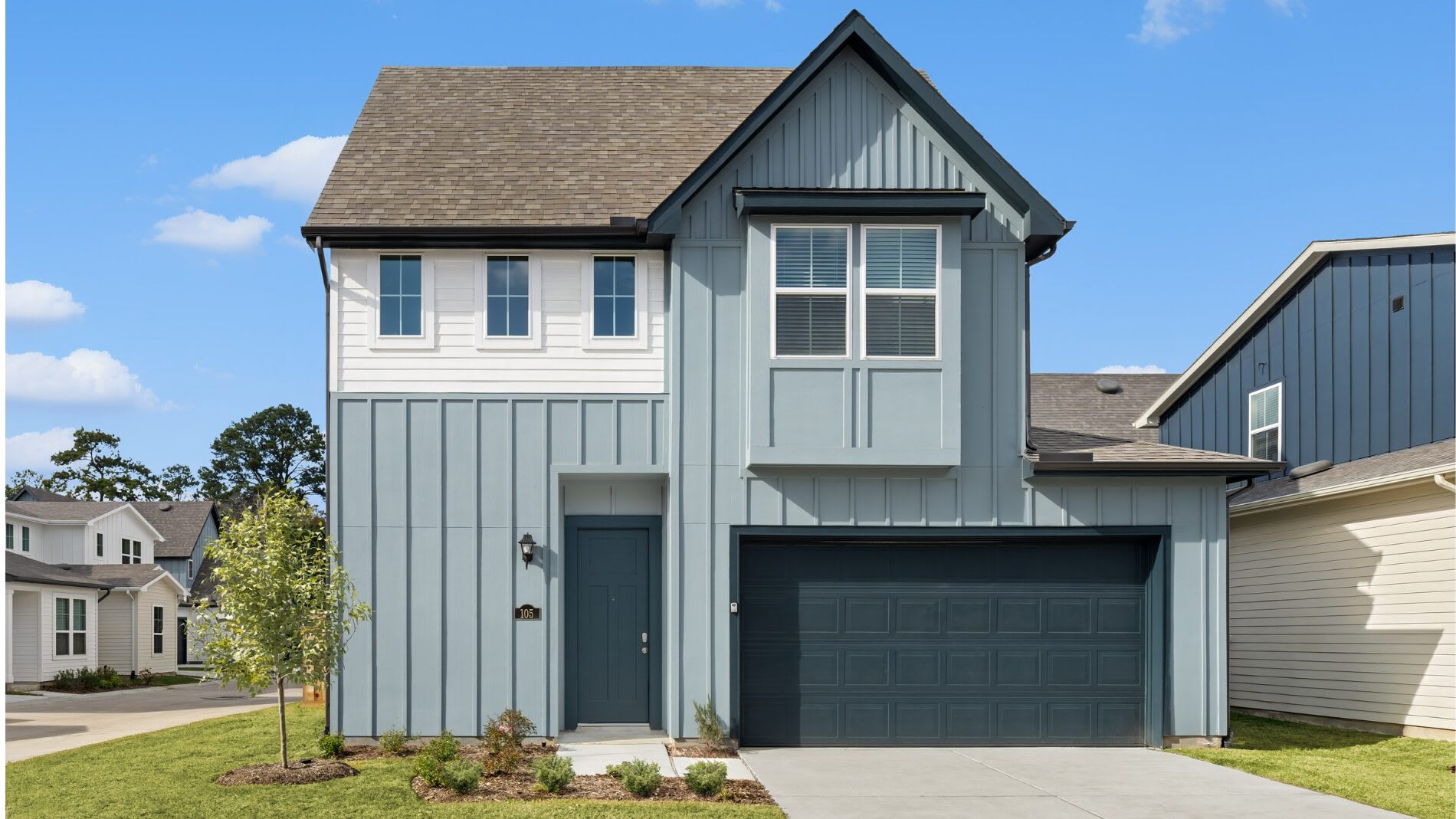 An exterior home with a blue and white Farmhouse scheme.