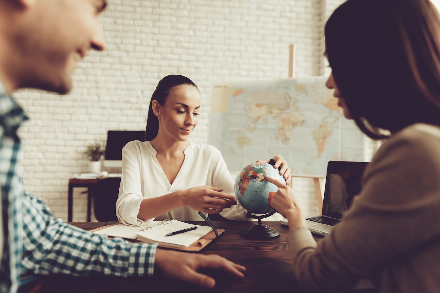 Travel agent speaks with a couple.